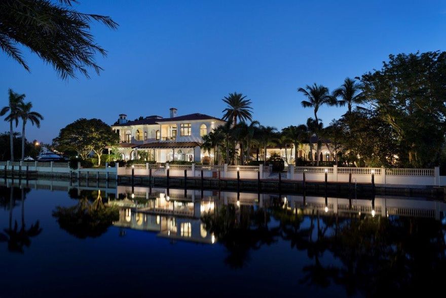 Giving glorious privacy and views on 208± feet of waterfront with yacht dockage, this one-of-a-kind Palm Beach-style estate stretches across two deepwater properties, set behind high hedges and landscaped with lush specimen trees.  As the centerpiece of the resort-style outdoor entertainment area, the formal pool is surrounded by a coquina stone patio among colonnaded loggias and swaying palm trees.  Hosting a full cabana bath plus an exercise room/bedroom, the poolside guest house opens to another outdoor living space featuring a fireplace plus an adjacent full kitchen and storage room.