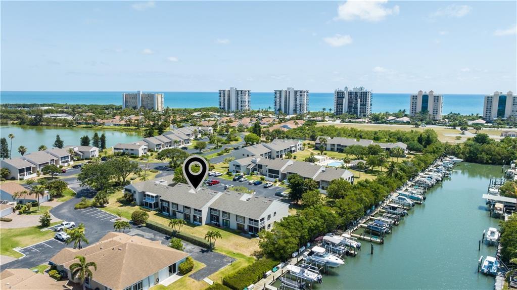Live the Florida dream in this modern coastal townhome nestled in a premier waterfront community. Available but sold separately is a boat slip w/13,000 lb lift, you're just minutes from open water via the Fort Pierce Inlet--ideal for effortless days on the boat. Unwind on the screened porch overlooking a private, fenced yard or take advantage of the community's boardwalks, tennis courts, & pool w/both beach & Intracoastal access. Inside, enjoy a sun filled layout w/multiple sliders, a serene master suite with dual vanities, and stylish, relaxed furnishings--negotiable to make your move seamless.