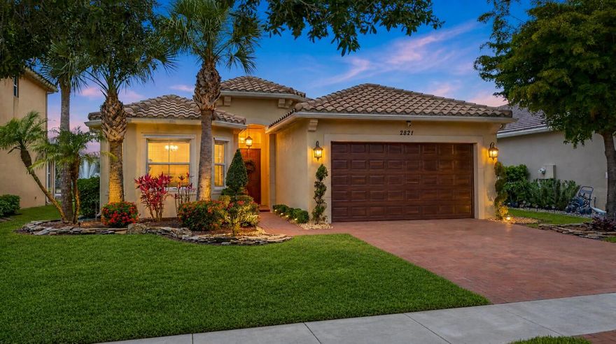 Exquisite Fully Renovated Smart Home with Sunset Lake Views and Heated Saltwater Pool. Welcome to 2821 Bellarosa Circle, a stunning Mediterranean-inspired residence that seamlessly blends sophisticated design with modern functionality. This fully upgraded open concept 3-bedroom, 2-bathroom, 2-car garage home features a thoughtfully designed split floorplan, offering both privacy and elegance. Step inside to a bright, freshly painted interior flooded with natural light, showcasing driftwood-toned vinyl floors, shiplap accent walls, arched openings, and dazzling designer fixtures. Lutron Smart Switches throughout, Ring Doorbell & Camera, and integrated surround sound elevate everyday living, while custom built-in closet systems provide unparalleled storage in every bedroom.  The heart of the home is the chef's kitchen, featuring a gorgeous oversized center island, white cabinetry with accent lighting, quartz countertops, a custom pantry, and upgraded stainless steel appliances, including a smart air fry oven. Adjacent to the kitchen, a formal dining room provides the perfect space for elegant gatherings and entertaining. A spacious laundry room adds convenience with abundant cabinetry, a deep basin sink, and luxury side-by-side appliances. The primary retreat is a serene sanctuary with lake views, coffered ceiling, dual walk-in closets, and a spa-like en suite featuring a chandelier, oversized walk-in shower, and dual-sink vanity. Two additional bedrooms and a guest bathroom are perfectly positioned toward the front of the home. Step outside to your private oasis and enjoy the most mesmerizing sunset views: a heated saltwater pool with sundeck, travertine patio, summer kitchen with an icy cold beverage refrigerator and gourmet grill, surround sound, and voice-activated roll-down screens. The fully fenced backyard with lush turf grass offers space, privacy, and effortless entertainment. The home's Mediterranean facade is complemented by a paver driveway, elegant entry, and meticulous landscaping. Other Smart Home features include automation for the pool and Wi-Fi enabled thermostat. Situated in a gated community with resort-style amenities, residents enjoy a stately clubhouse, pool, tennis and pickleball courts, billiards, gym, children's play area, and splash pad. This is not just a home—it's a lifestyle. With every detail thoughtfully curated for comfort, style, and convenience, 2821 Bellarosa Circle is an exceptional opportunity to embrace luxury living in a vibrant, amenity-rich community.