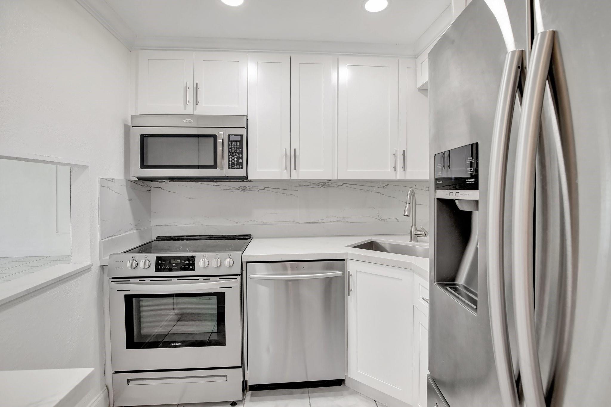 This stunning one bedroom, one bathroom corner unit in the prestigious 55+ community of Sunrise Lakes has been tastefully updated and is ready for immediate move-in. Featuring tile flooring throughout, a custom-built kitchen with sleek quartz countertops and high-end stainless steel appliances, this home perfectly blends style and functionality. The bright, open layout is complemented by modernized bathroom and a serene view of the lake. This home also features new 2024 AC and water heater. Enjoy resort-style amenities, including a clubhouse, courtesy bus, pools, tennis courts, and more. Maintenance conveniently covers cable, water, and trash.