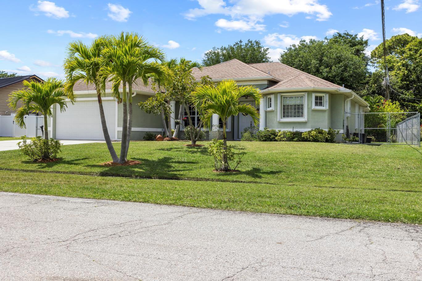 Come live the life free of HOA fees,rules & regulations. This home is on just over 1/4 acre fenced & beautifully landscaped lot. Home has new roof & recently replaced A/C. The spotless interior offers 12 ft ceilings with a open concept. Tile floors throughout.NO carpet.Primary bedroom has his & her closets, huge bathroom including roman tub with double shower & dual sinks.Office can be converted to 4th bedroom if needed. Kitchen has Cherry cabinets & granite countertops.Step out to a covered patio & enjoy the serene back yard. Extra wide driveway for extra cars or toys.All located near restaurants, shops, hospitals and places of worship & most beautiful beaches on the Treasure Coast .Come make it yours.