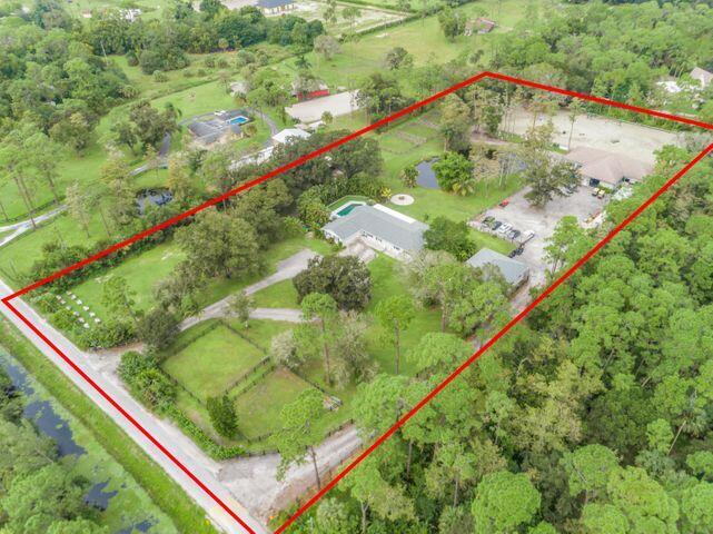 This 5 acre Equestrian facility & home is located directly off Southern & B Rd. Only 13 minutes to WEF, International Polo Club & walking distance to Publix & tractor supply plaza. The main residence has 5 BD/ 3 BA and has been fully renovated. See additional remarks for the full list of upgrades. 2743 under air with a 2 car garage. 2 master suites, one of them has a fireplace and beautiful soaker tub. There are two entrances to the property, one leads to the home and the other to the 12 stall barn, and insulated Ag Building (Built as an 8 stall barn). 4 wash racks, two tack rooms, qrooms qtr. Behind the large barn is a 125x225 riding arena (28,125sf) with sand footing-base, paper, stone w/drainage pipe buried inside base,T-rail fencing and fully irrigated. SEE MORE......