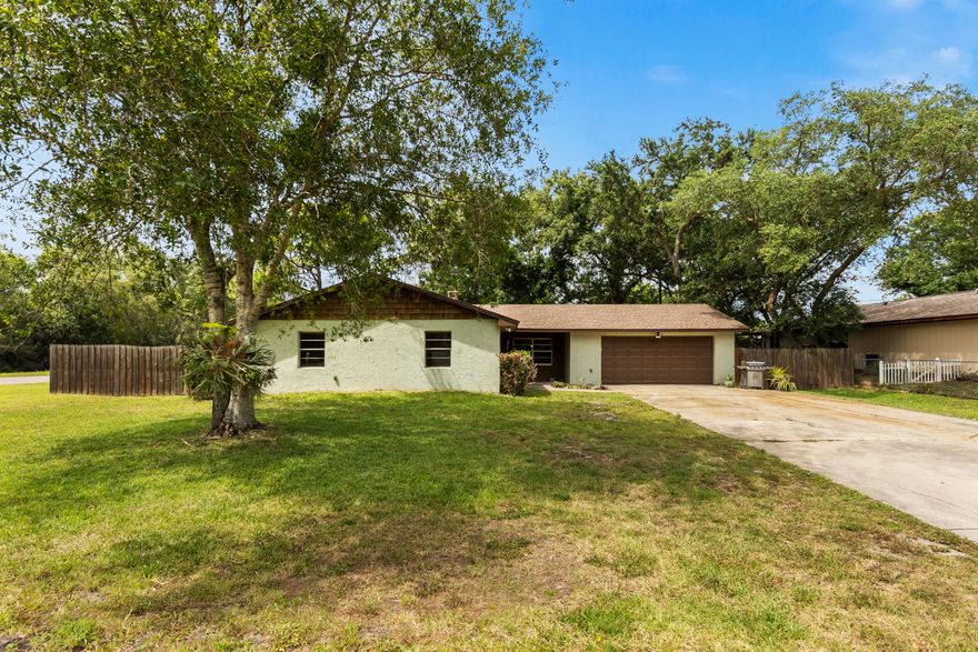 This charming 3/2/2 in Lakewood Park offers concrete block construction with 1,870 living SF. The roof was just replaced in 2021 and A/C was done in 2016. This home sits on a .31/acre corner lot across from a canal with a huge fenced in backyard equipped with a dual gate side entrance. Perfect for boat/RV/trailer storage. Theis cozy interior features a formal living room & dining room, spacious eat-in kitchen, finished Florida room and a convertible bedroom/office off the laundry room. Lakewood Park offers 25 lakes you can fish in, 2 public green areas, and two community parks. Only 20 minutes from the beach & 5 minutes to I-95.