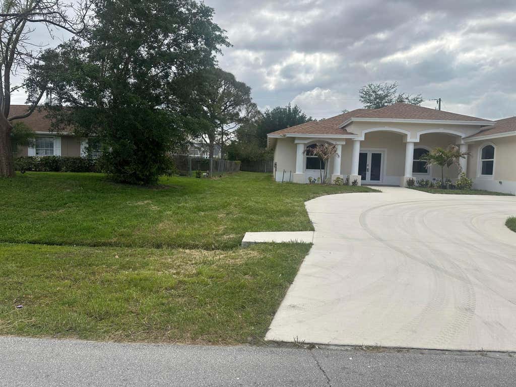 Photo of 1908 SW Americana Street, Port Saint Lucie, FL 34953 (MLS # B26041999)