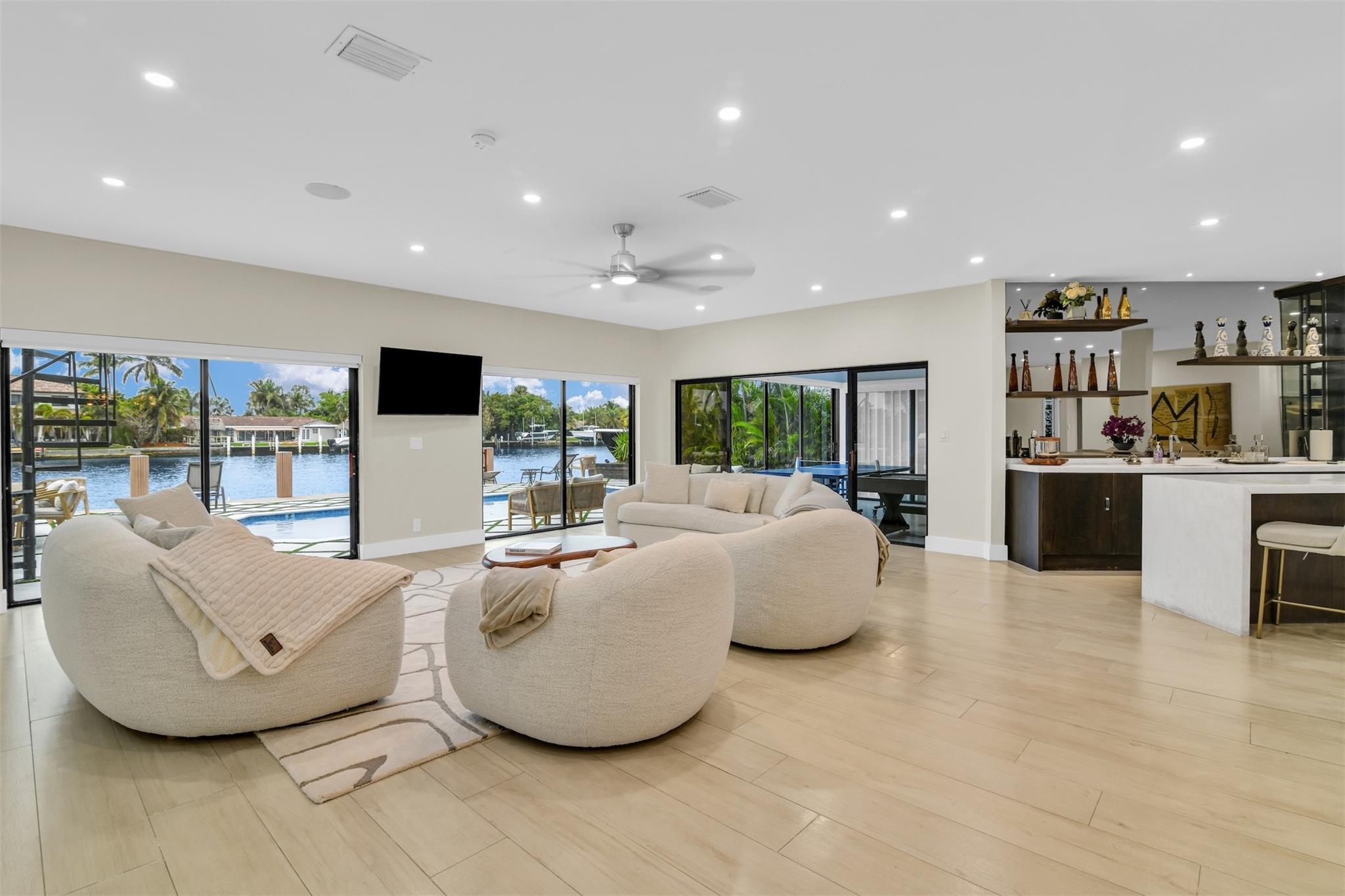 Stunningly remodeled, intracoastal front 6 bedroom, 6 bathroom home ready for you to move in. Every inch of this property as been transformed with the finest finishes. Beautiful foyer welcomes you into this 5,196 square foot masterpiece. Chef's kitchen is dressed with Cristallo Island, SubZero refrigerator and freezer, Wolf range, and wall espresso machine. The wet bar with wine cooler leads you to your open family room and formal dining room with incredible views of the intracoastal waterway. Summer kitchen for entertaining at your gorgeous pool overlooking 60 ft. dock. Fully equipped theater room + separate office on the first floor. Second floor has very large loft and coffee bar along with a fireplace. Primary bedroom boasts water views and extra large shower with dual shower heads.