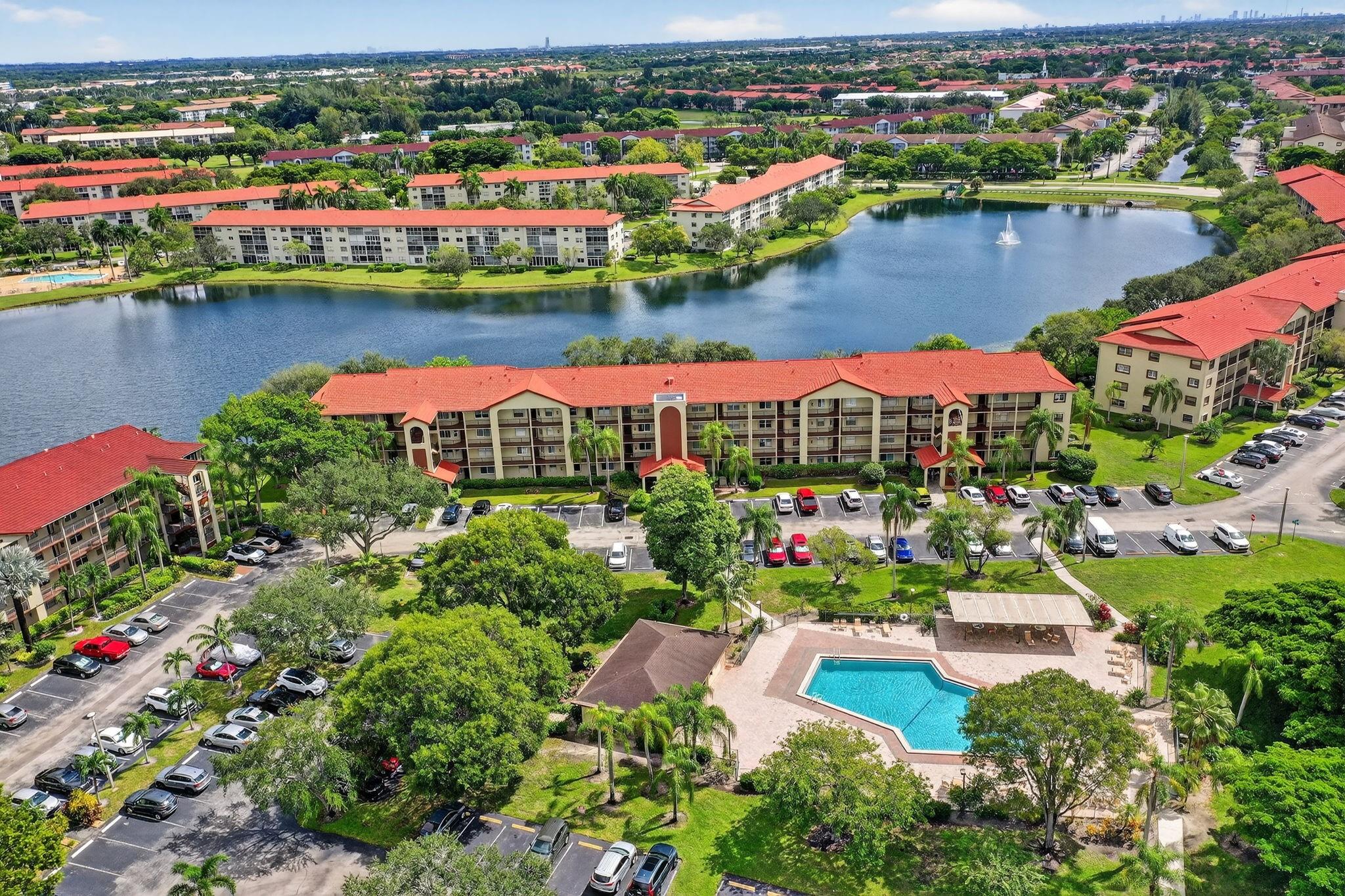 LAKE VIEW -Spacious and bright Karanda model, 2nd largest floor plan in Century Village (1,356 SF). 2BR/2BA with remodeled kitchen & baths, recessed lighting, modern touches, oversized walk-in closets, breakfast nook & galley kitchen. Enjoy beautiful LAKE views from the patio plus partial clubhouse view & POOL VIEW from the front. Hurricane shutters, plenty of parking, building faces south near Pembroke Road gate. Water, cable & internet included in maintenance. Century Village offers clubhouse, tennis, pools, fitness center, courtesy buses, 24-hr security & more! Active 55+ community with endless activities, shows & social events. No rentals 1st year. 650 min credit score required.