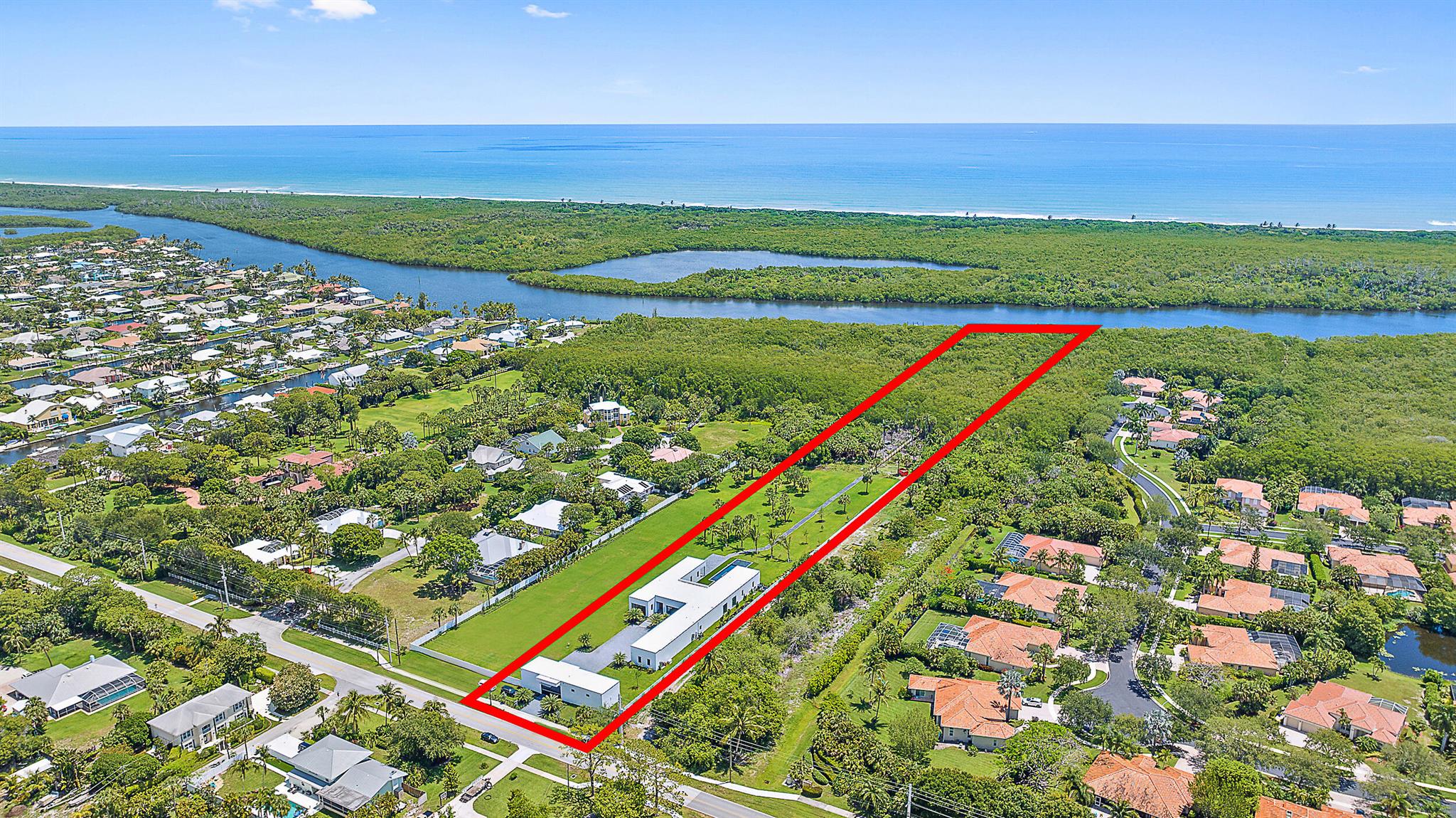 Built in 2022 on over 4 acres, this exceptional property is a dream for car collectors and boaters alike, offering 8 garages (with room for lifts) and direct Intracoastal access. Sleek lines and floor-to-ceiling windows showcase the estate's expansive grounds and resort-style pool. The main house features, eye catching design, a media room/theater, office/exercise room, and other amenities making it perfect for hosting or working from home. The detached guest house offers a full bath, kitchen, and laundry. The vacant lot is potentially available for purchase upon inquiry. The luxurious owner's retreat includes wood floors, a cozy fireplace, a marble bath with dual sinks and water closets, and a walk-in boutique-style closet. The state-of-the-art kitchen is equipped with dual wall ovens, a