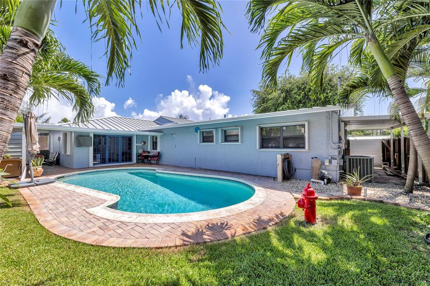 Exceptional value in Central Wilton Manors! Short walk to Wilton Drive, Rosie's, steps to Publix, CVS, dining, and nightlife, PLUS just 2 miles to Fort Lauderdale beach. This 3BR, 2.5BA home features a 2018 standing seam metal roof, impact front door, and full accordion/Bahama shutters for storm protection. This home is MUCH LARGER than it appears from the street! Enjoy an open layout with a HUGE family room (no step-downs) and French doors to a private pool. Includes indoor laundry, generous closets, 1-car garage with impact door, and oversized carport with 11'4" clearance—perfect for your RV or boat, secured by custom aluminum gates. A rare find with lifestyle, location, and long-term value for Airbnb scenario as well. Sellers will consider all offers --house ready for new owner!