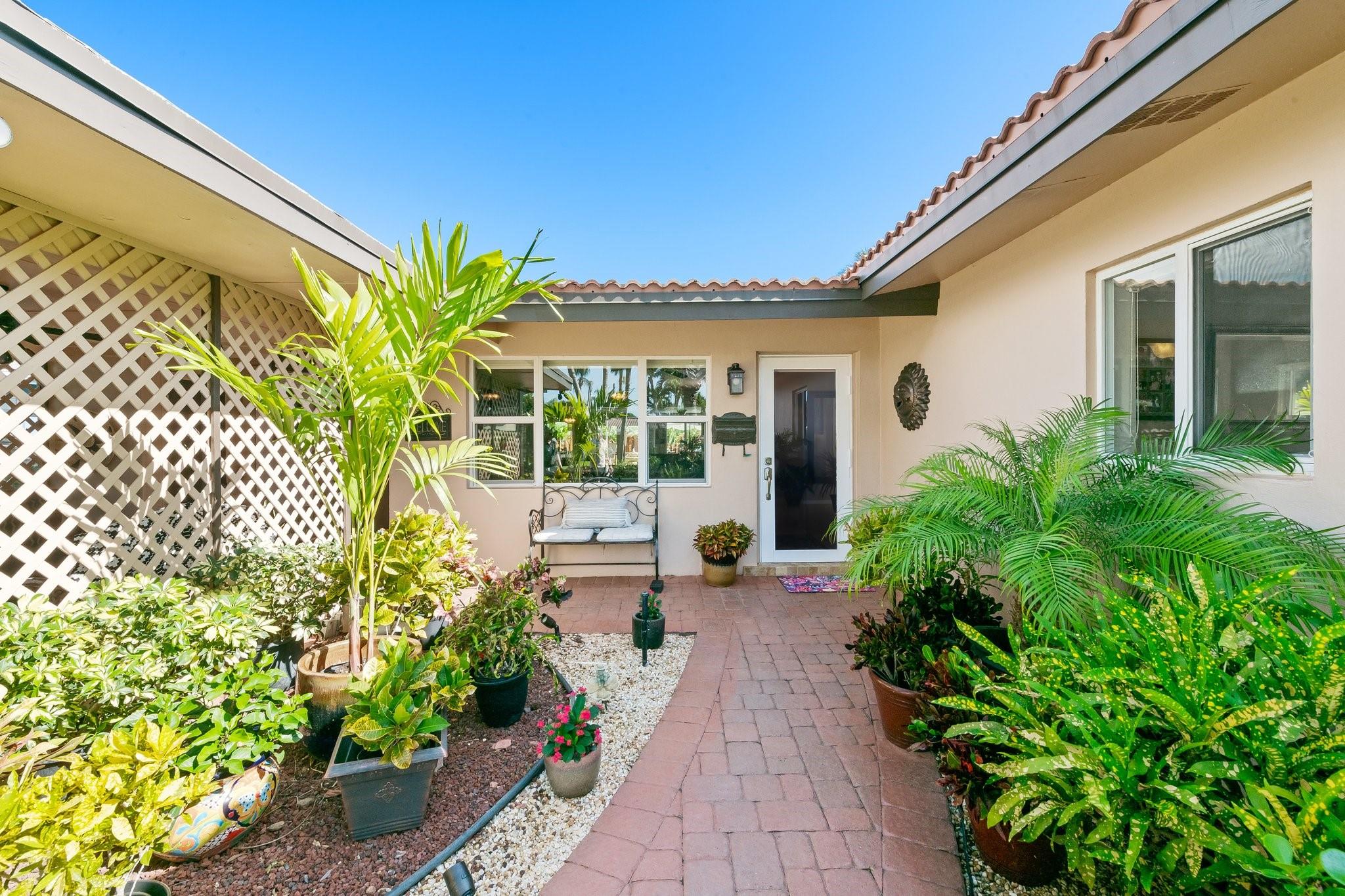 Tucked away on a quiet, non-cut-through street in the heart of Lighthouse Point, this charming home offers the perfect blend of comfort and coastal living. Enjoy your morning coffee on the covered patio, surrounded by lush tropical landscaping that makes every day feel like a getaway. The open, airy layout invites natural light to pour in, creating a warm, welcoming space that’s perfect for both quiet mornings and lively evenings with friends. Featuring a 2021 roof, impact windows/doors (with the exception of the front door), and a new electric panel with underground FPL service, this beautiful home is just minutes from beaches, dining, and shopping. Don’t miss this peaceful retreat—schedule your private showing today! Sqft from owners.
