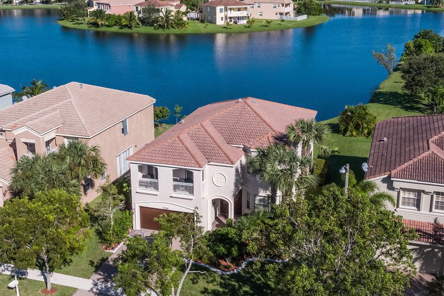 This is the home you have been waiting for! Amazing Vizcaya model on premium lake lot in highly desirable Olympia! Eye catching curb appeal including freshly painted exterior welcomes you inside where you will be wowed by the soaring ceiling & elegant spiral staircase. The formal living room is open to the formal dining room which offers sliders that provide stunning lake views! The chef's dream kitchen features NEW stainless steel appliances, 42'' cabinets, granite counters & island, decorative backsplash, & walk-in pantry. The upgraded kitchen is open to the breakfast area with bay windows providing panoramic lake views & family room. The family room is spacious & has sliders that lead out to the patio. The half bath is ideal for guests. A luxurious spiral staircase leads up to the 2nd level. The master suite features 2 walk-in closets & an en-suite bath with dual vanities. The additional bedrooms upstairs are spacious and there is also another full bath with dual sinks. The upstairs balcony is another bonus! Step outside to your own private paradise! The newly screened patio is perfect for BBQs & outdoor entertaining. Relax & enjoy the sweeping lake view from your spacious yard which has plenty of room for a pool! This home features upgrades throughout including freshly painted interior & exterior, new appliances, new washer & dryer, new screen enclosure, & so much more! Olympia is a gated community located in close proximity to A-rated schools, fine dining, shopping, & the world renowned equestrian village of Wellington. Olympia has resort style amenities including a state of the art clubhouse with indoor basketball, fitness center, lagoon style pool with private cabanas, water park for kids, 4 lighted tennis courts, volleyball courts, & so much more!