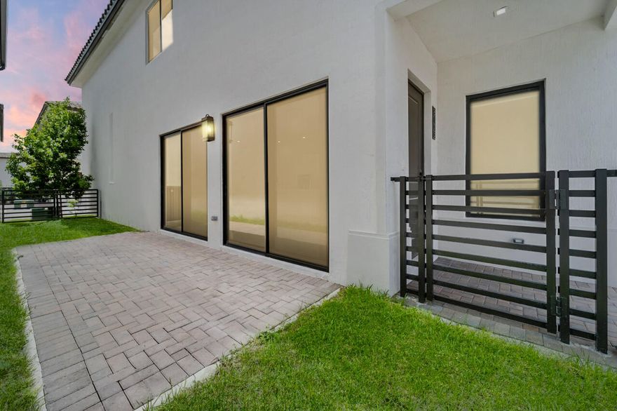 Experience contemporary living in this beautiful 2-story home in Downtown Doral Canarias. Boasting 4 spacious bedrooms and 3 elegant bathrooms, the open-concept layout is perfect for modern lifestyles. The first floor features a guest bedroom with a full bath, while the gourmet kitchen impresses with stainless steel appliances, marble countertops, and a custom backsplash, flowing seamlessly into bright living and dining areas with soaring ceilings and expansive windows. Upstairs, the master suite offers a spa-inspired bathroom and custom closet, complemented by two additional bedrooms with custom closets and a versatile den. Enjoy resort-style amenities including a pool, kids' splash pad, fitness center, and indoor basketball courts. Conveniently located minutes from City Place, top-rate