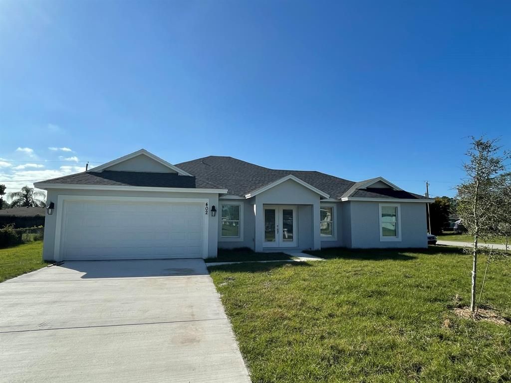 Photo of 402 SE Lancaster Avenue, Port Saint Lucie, FL 34984 (MLS # R10878149)