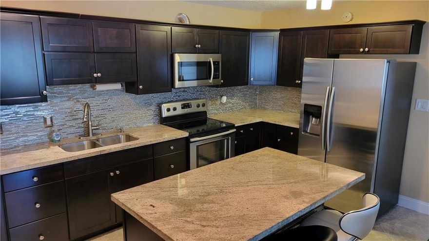 Gorgeous corner unit in great complex 2.8 miles from the Beach. Beautiful open kitchen with large island. Granite counter tops, plenty cabinet space. Stainless Steel appliances. Diamond tile pattern. Nice built-in the living room, perfect for TV and storage. Brand new roof getting installed,  already approved by the association,  going trough permits.  Well maintained complex. Heated pool in clubhouse. Fitness and game room, BBQ area and more. One assigned parking space, plus plenty guest spots.  Laundry facility is on the same floor. Extra storage locker for each unit. It can be rented after 2 years.  WOULD NOT LAST..!!!  :)