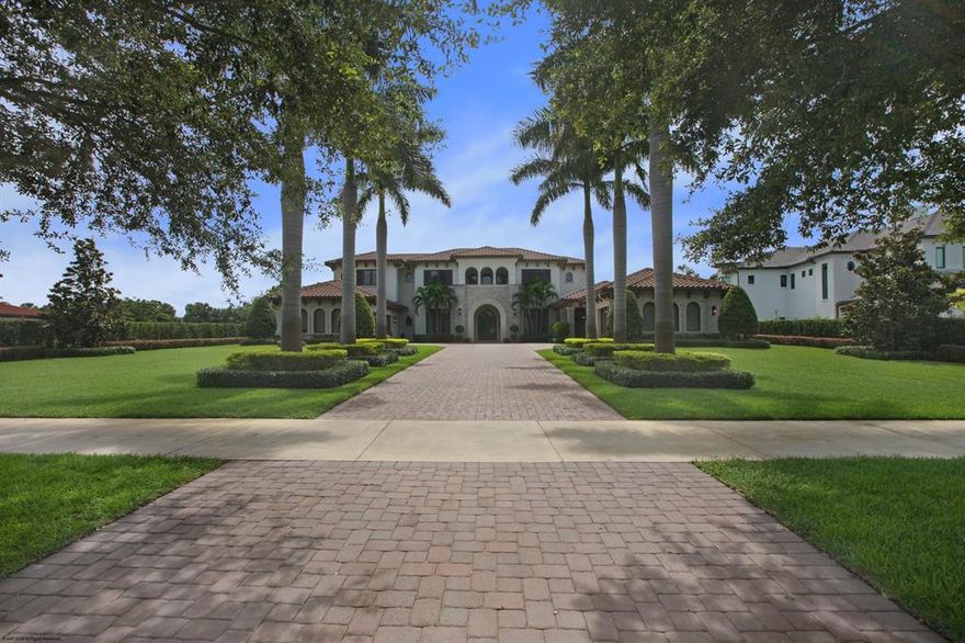 A commanding presence on the most sought-after street, this large yet comfortable home, new in 2013, has been stylishly updated and tastefully refined.  Beautifully manicured with over three-quarters of an acre with golf course and water views.  Impressive palm tree-lined driveway leads to a beautiful entryway lined in stone and cedar.  An entertainer's dream inside and out.  Boasting a bright, airy, and open floorplan with French travertine, the ultimate summer kitchen with sitting area, dining area, and bar, and sprawling backyard.  This home is designed for indoor-outdoor living.  Master suite downstairs, with plush carpet and sitting area with fireplace.  His and hers bath areas befitting a home of this caliber.  Your perfect kitchen features