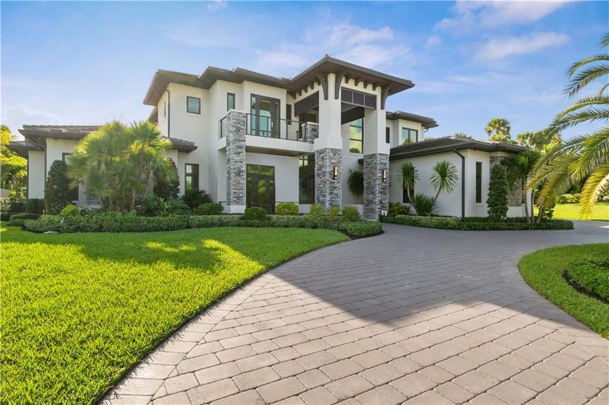 Situated along the rolling green fairways of the Parkland Golf and Country Club, this stunning modern architectural showcases a thoughtful contemporary style. Two stories of open-plan, exquisitely designed living space include seven bedrooms, eight and one-half bathrooms, a state-of-the-art chef’s kitchen with dual waterfall islands, a 1000-bottle, glass-enclosed wine room, a wet bar, and a four-car garage. Soaring double-height ceilings rise above the living room, which flows effortlessly to the outdoor living space with an infinity-edged pool, heated spa, fireplace, entertainer’s deck and lush landscaping. Capturing picturesque lake and golf course views, the expansive end homesite with a 4-car garage is nestled along a leafy, green reserve on a quiet cul de sac.