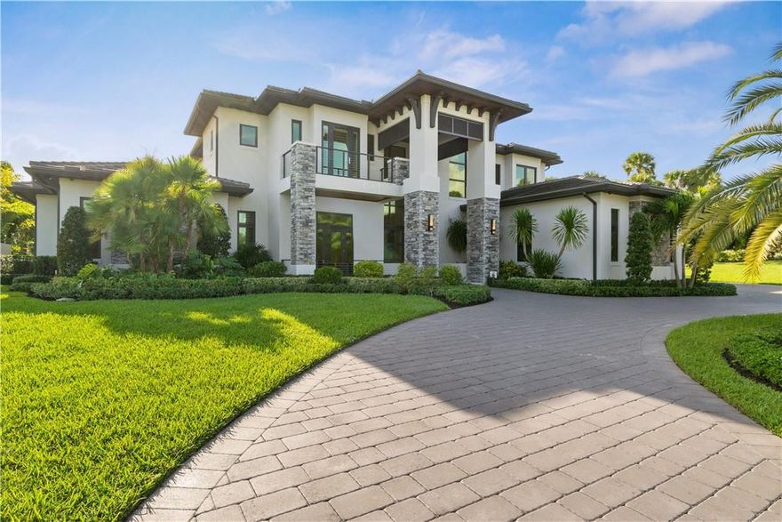 Situated along the rolling green fairways of the Parkland Golf and Country Club, this stunning modern architectural showcases a thoughtful contemporary style. Two stories of open-plan, exquisitely designed living space include seven bedrooms, eight and one-half bathrooms, a state-of-the-art chef’s kitchen with dual waterfall islands, a 1000-bottle, glass-enclosed wine room, a wet bar, and a four-car garage. Soaring double-height ceilings rise above the living room, which flows effortlessly to the outdoor living space with an infinity-edged pool, heated spa, fireplace, entertainer’s deck and lush landscaping. Capturing picturesque lake and golf course views, the expansive end homesite with a 4-car garage is nestled along a leafy, green reserve on a quiet cul de sac.