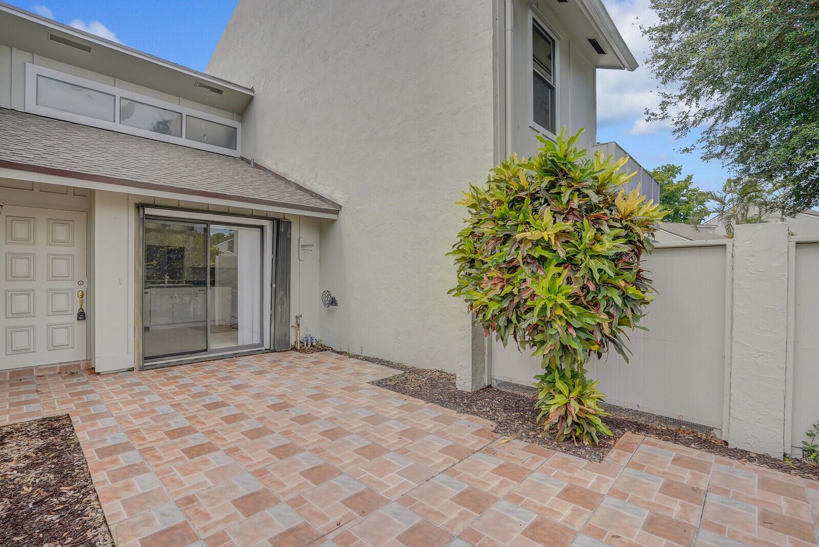 MOTIVATED SELLER, BRAND NEW ROOF & NEW CARPETING IN BEDROOMS! This villa features a quaint courtyard entry to a 2-bedroom, 2-bath villa with a 2-car garage in the Hidden Landings community-a hidden gem! Community is close to all the equestrian venues, shopping, restaurants, and entertainment, . Spacious open floorplan--Large tiled living/great room and dining area with a pass-thru to the kitchen. Kitchen has stainless appliances and additional cabinets that have been added. Kitchen's sliding doors open to that secluded entry courtyard-Perfect for your morning coffee! The 2 bedrooms are carpeted and each has own bathroom. Both bedrooms and living room have sliding door access to the large, rectangular covered patio that overlooks the canal. All this and Accordion Shutter protection, too