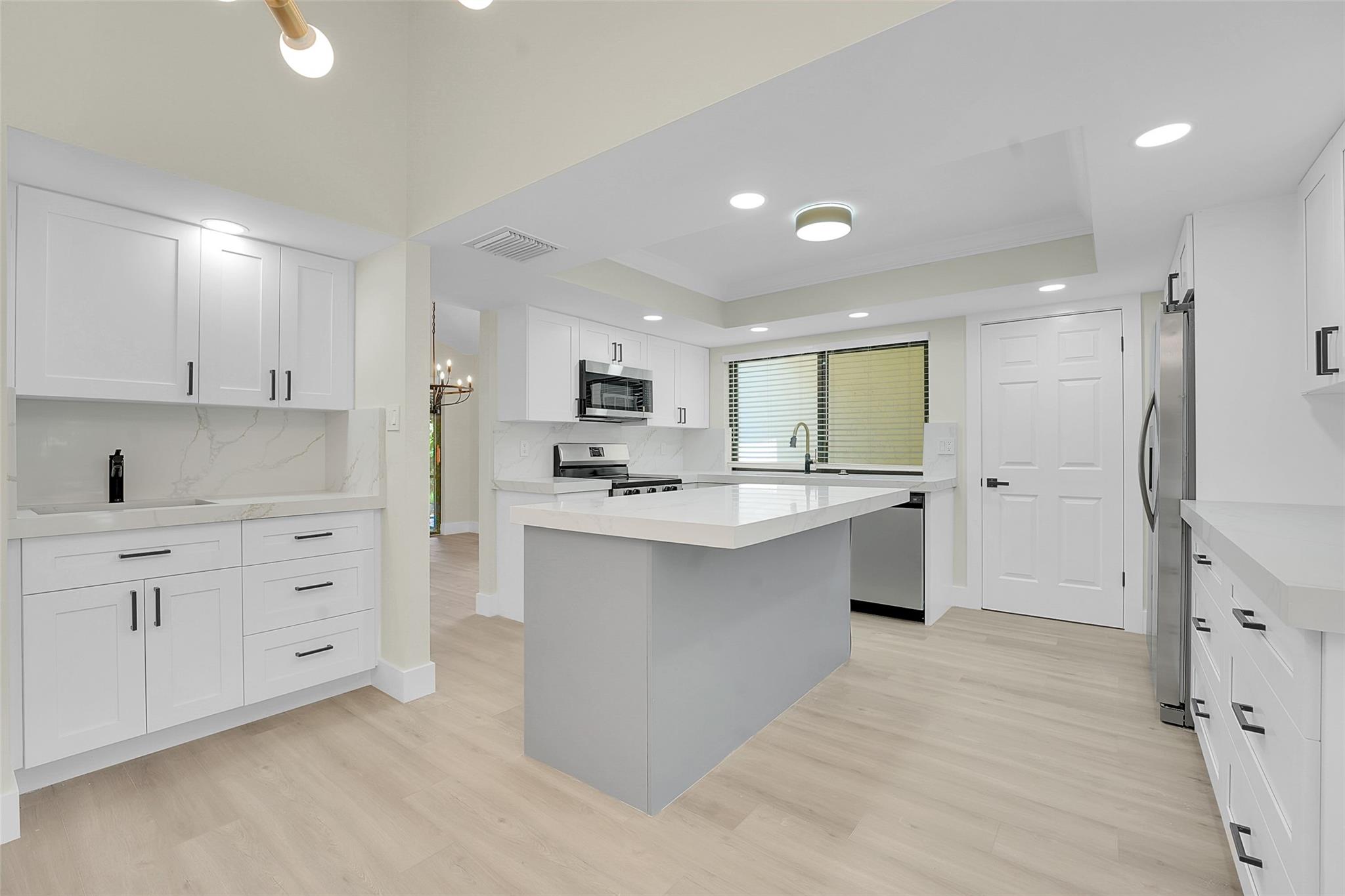 An exceptionally remodeled 2 bedroom 2 bathroom villa in the coveted Twelve Oaks community. The home has over 1900 sq ft of living space featuring luxury vinyl flooring throughout, renovated kitchen with high-end appliances, renovated bathrooms, vaulted living room and a 1 car garage. Outdoor living is abundant with an open back patio and walk to the docks less than 2 minutes. Comprehensive HOA that includes insurance and roof. Just steps away from onsite marina with multiple pools, a clubhouse and tennis/pickleball courts...it's the perfect Florida oasis. Must see to appreciate!