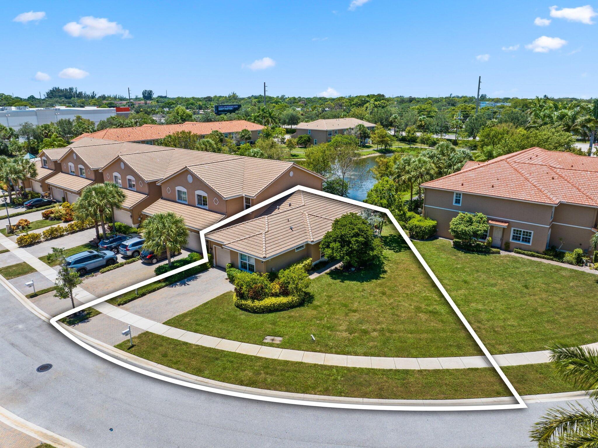 One-of-A-Kind expanded lot, on lake, Immaculate, move-In ready townhome in gated community!!! This beautifully kept townhome offers the perfect blend of comfort, convenience, and style. Built in 2014 and used only sparingly, the property is in pristine condition. One-car garage plus driveway parking for two additional vehicles, tile and laminate flooring throughout, impact windows,granite countertops with ceramic backsplash, stainless steel appliances, open, bright living spaces. Ideally located just minutes from I-95 and the Florida Turnpike, you'll enjoy quick access to shopping, dining, Palm Beach International Airport (15 minutes).