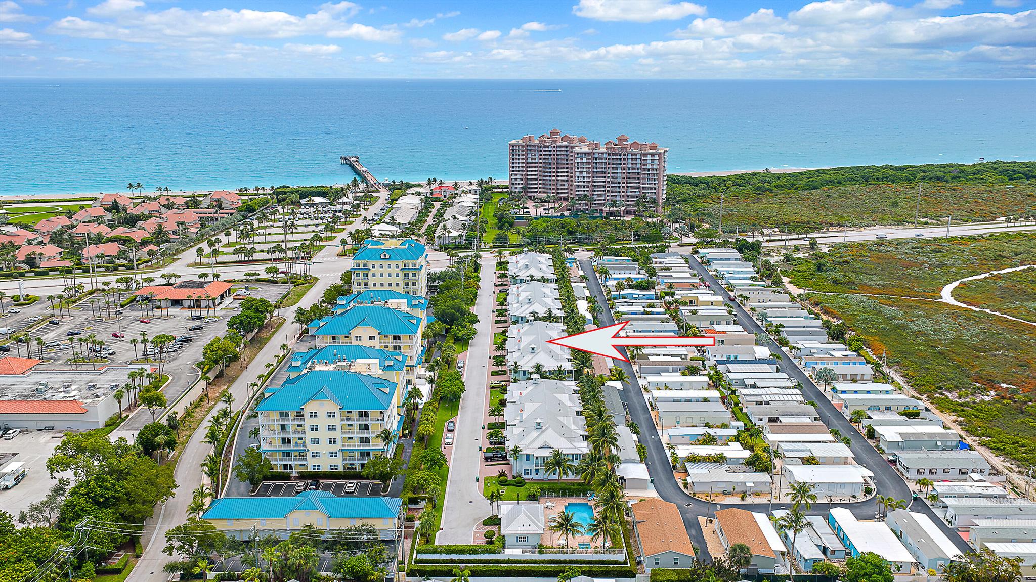 UNFURNISHED ANNUAL RENTAL AVAILABLE OCTOBER 1, 2025- JUST STEPS FROM THE BEACH AND THE JUNO PIER! This beautifully maintained, like-new townhome offers 3 spacious bedrooms, all with walk-in closets, impact-rated windows and doors, high ceilings, and a bright open-concept layout. The kitchen features granite countertops, soft-close 42'' wood cabinetry, a large island, bar area with beverage cooler, and top-of-the-line stainless steel appliances. The primary suite is a true retreat with its private balcony, double shower, and elegant dome ceilings. A unique highlight of this home is the screened-in patio ''a rare find in this community'' perfect for enjoying ocean breezes in comfort and privacy. Flooring includes a mix of ceramic tile and wood for a stylish yet cozy feel throughout.