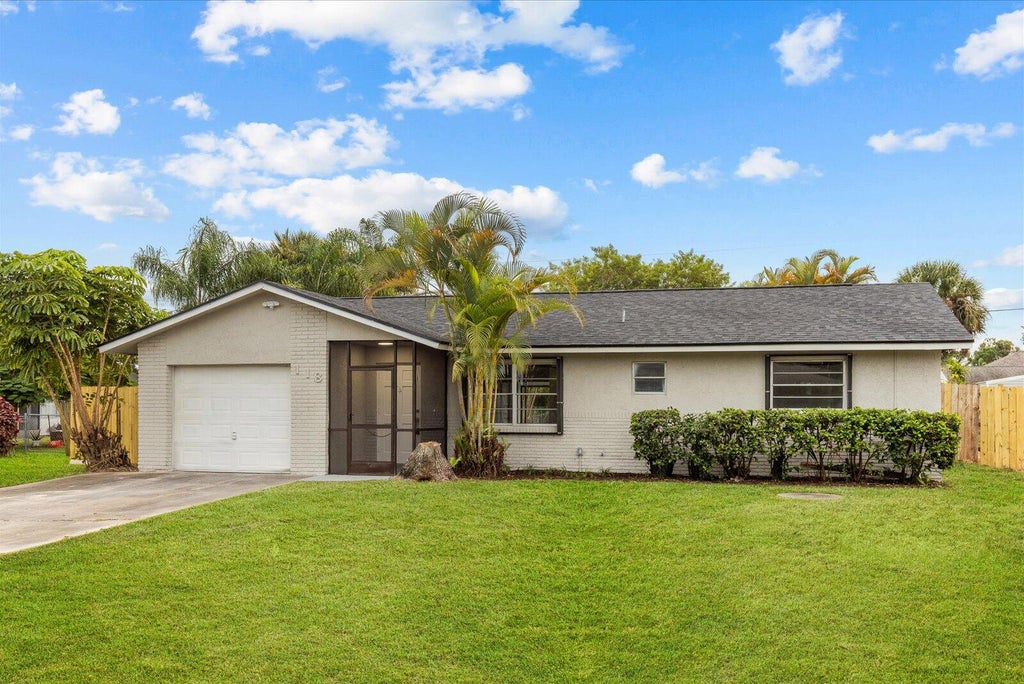 Photo of 118 SW Lancaster Avenue, Port Saint Lucie, FL 34984 (MLS # R11138901)