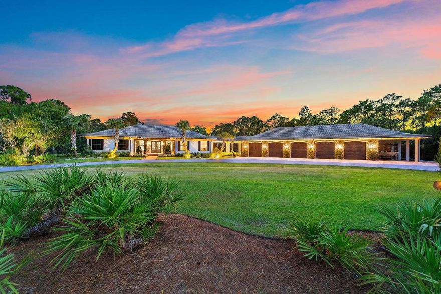 You may have heard it before, but THIS home is truly one of one. Situated in the heart of Jupiter in a private, gated sanctuary on over 5 acres is a 4-bedroom, 4.5-bathroom residence with office/flex room, theatre, game room and wine room. It was built in 2016 by renowned local luxury builder D&D Specialties. Touting 5,500 square feet of living space AND a 3,000 square foot, air-conditioned 10+ car garage complete with its own office and gym. Entertain guests or keep your skills sharp on your personal par three golf hole. Take a dip in the stunning pool with champagne hot tub and beautiful Ipe wood deck. Natural and manicured landscaping provides a dramatic approach and solitude from the outside world. Luxury, beauty and privacy, only minutes from everything the area has to offer.