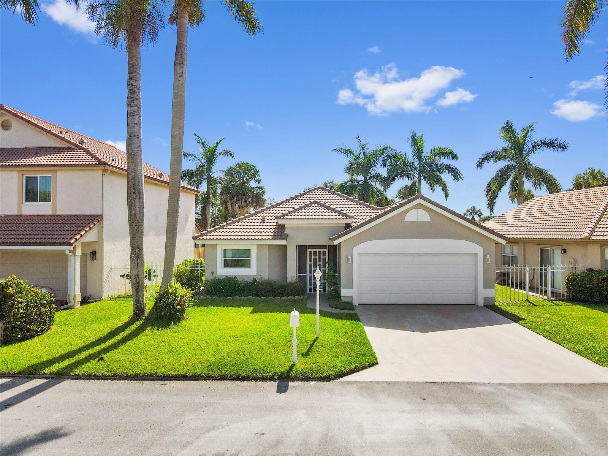 Beautifully renovated 2 bed, 2 bath home with 2-car garage in desirable Boca Chase. Designer kitchen features quartz countertops and rectified porcelain flooring, with vaulted ceilings enhancing the open living space. Living room is prewired for surround sound. Spa-like primary bath offers a soaking tub, separate shower, and illuminated mirror; guest bath is also stylishly updated with illuminated mirror. Impact windows throughout and roof replaced in 2014. Spacious patio in fenced yard. Community offers pools and tennis courts.
