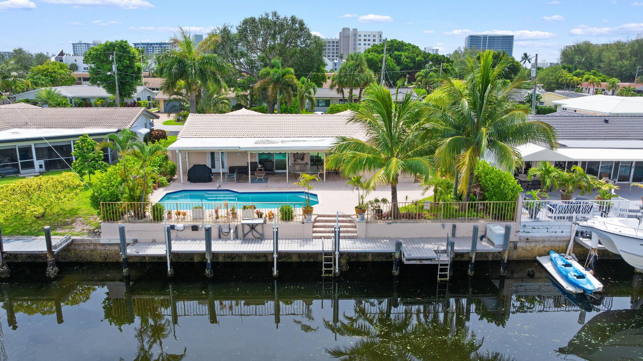70FT OF WATERFRONT! With 3 bedrooms and 2 bathrooms, this meticulously maintained waterfront home is a short walk to the beach. Enjoy Florida's outdoor lifestyle with a saltwater pool, outdoor shower and a covered patio, ideal for relaxing or entertaining. This beautiful property has a 60ft dock, NO FIXED BRIDGES, NEW AC, and is a short boat ride to the Hillsboro Inlet. Complete with impact windows and doors (pass-through kitchen window and garage side door have shutters), located on a private cul-de-sac, and a circular driveway for ample parking. The single car garage provides additional storage, completing this perfect package. Minutes away from beautiful beaches, restaurants, shopping, parks and the Pompano Beach Pier.