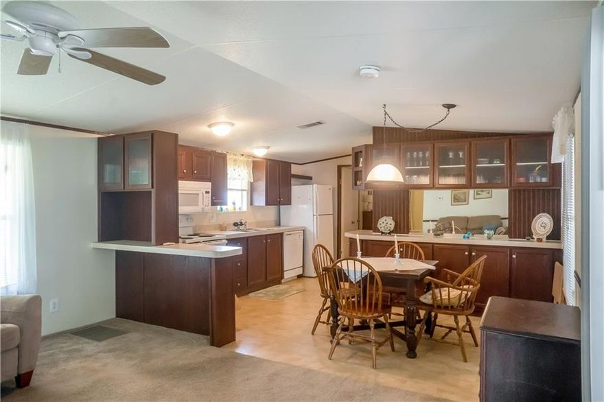 Spacious manufactured home. Land owned. Active 55 + community, Park City Single wide with additional screened porch and separate large workroom. Built in 2006 approx. 800 sq. ft. +- under air. Interior lot 56'x80'+-. Spacious kitchen with cabinets galore. Inside stacked washer and dryer.  Light and bright living area and dining area. Split bedroom two full baths.  Maintenance ($109) paid monthly for an array of organized activities, clubhouse, tennis and shuffleboard courts and community pool. Conveniently located to area shopping, dining, hospital and public transportation.  15 minutes to Ft. Lauderdale airport. Approximately 15 miles to the beach.