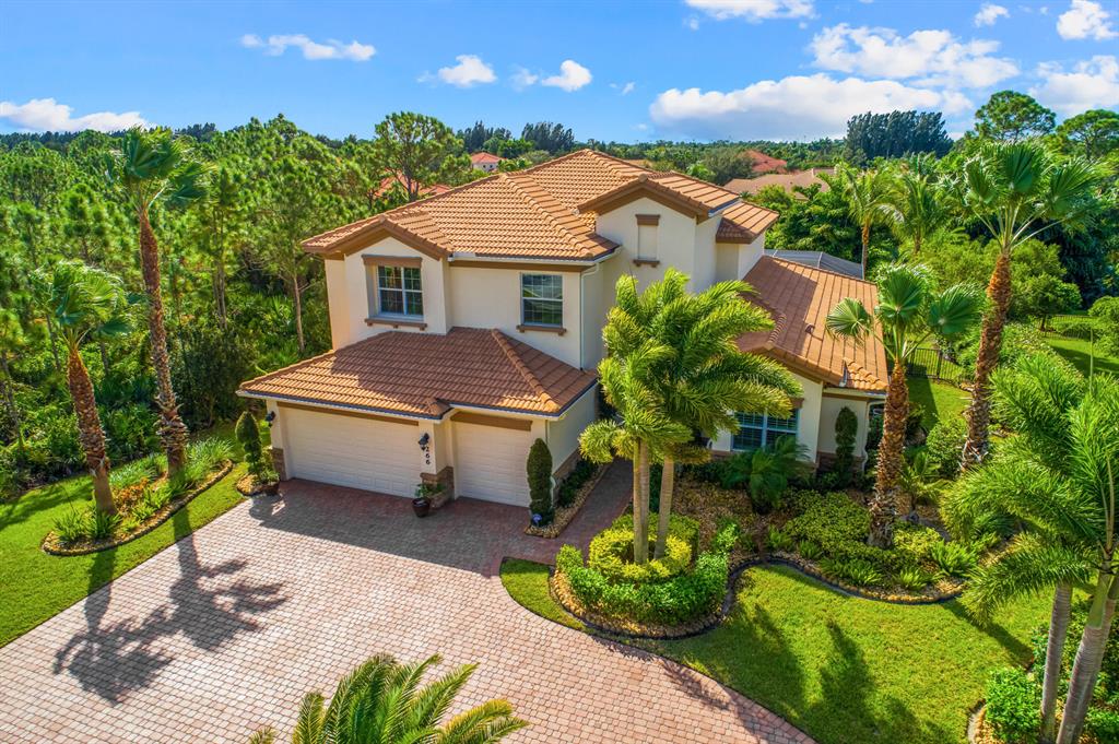 Welcome to the gem of Tres Belle, a luxury gated community. This amazing rare two story 5BR/4Bath Nassau Model one of a kind home built by famous Kolter Homes. With truly the most superior construction in Tres Belle you are simply in paradise at home in this secluded oasis up against a beautiful nature preserve. Located next to Palm Beach shopping centers and only 15 minutes from downtown Stuart and minutes from the interstate. Featuring Inside keypad controller heated saltwater pool and hot tub, luxury travertine stone in pool patio and lanai, built in grill and refrigerator under stone bar top. Home has porcelain and wood flr on 1st flr, impact windows/sliding doors w/ a reinforced garage door and a 22k Watt whole home gas generator and a ADT security system w/ camera
