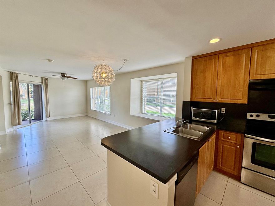 Welcome to 4855 Via Palm Lakes #912 — where comfort meets convenience in this serene, lakefront corner-unit condo.
This spacious two-bedroom, two-bathroom residence is ideally located on the ground floor, offering easy access and enhanced privacy with tranquil views of the water. Natural light pours through large windows, highlighting the open layout and airy ambiance throughout.

The kitchen features stainless steel appliances, complemented by modern lighting, ceiling fans, and low-maintenance tile flooring. Both bedrooms are generously sized with walk-in closets, and the primary suite offers sliding glass doors that open directly to your private patio  perfect for enjoying peaceful mornings or unwinding at sunset. The living area also connects seamlessly to the patio, providing a true indoor-outdoor lifestyle.

Additional highlights include an in-unit washer and dryer, a dedicated storage room, and two assigned parking spaces. The unit is offered unfurnished, giving you the freedom to customize and make it your own.

Pet-friendly with owner approval (small pets only) and available for annual lease. Per the HOA, tenants must have a minimum 620 credit score and a clean background check.

As a resident, you'll enjoy access to community amenities such as a clubhouse, fitness center, tennis courts, and a resort-style pool. Plus, you're just minutes from downtown West Palm Beach, Palm Beach Atlantic University, shopping, dining, and beautiful area beaches.