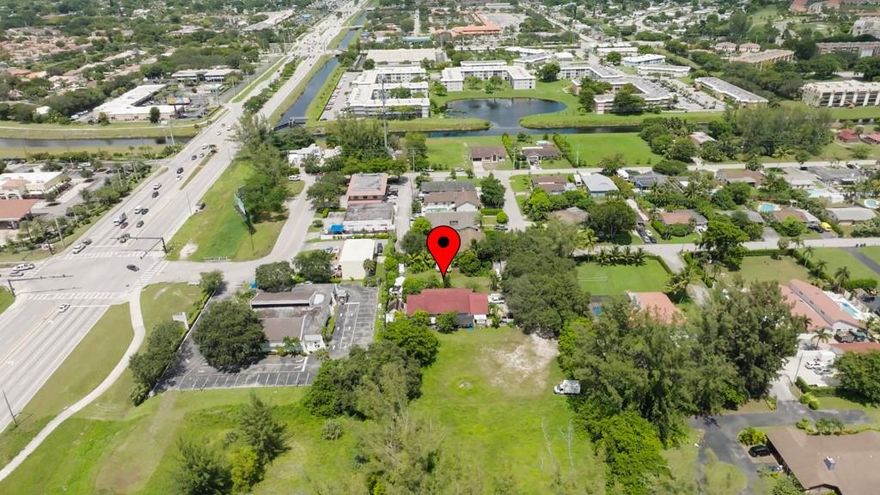 LOCATION, LOCATION, Water, and Sewer are on site. Across from the Shopping center off State Road 7/441. The property has an income-producing residential duplex and a SITE FOR ANOTHER DUPLEX. Nearby hotels, Walmart Superstore, shopping center, major Hwys, and much more.