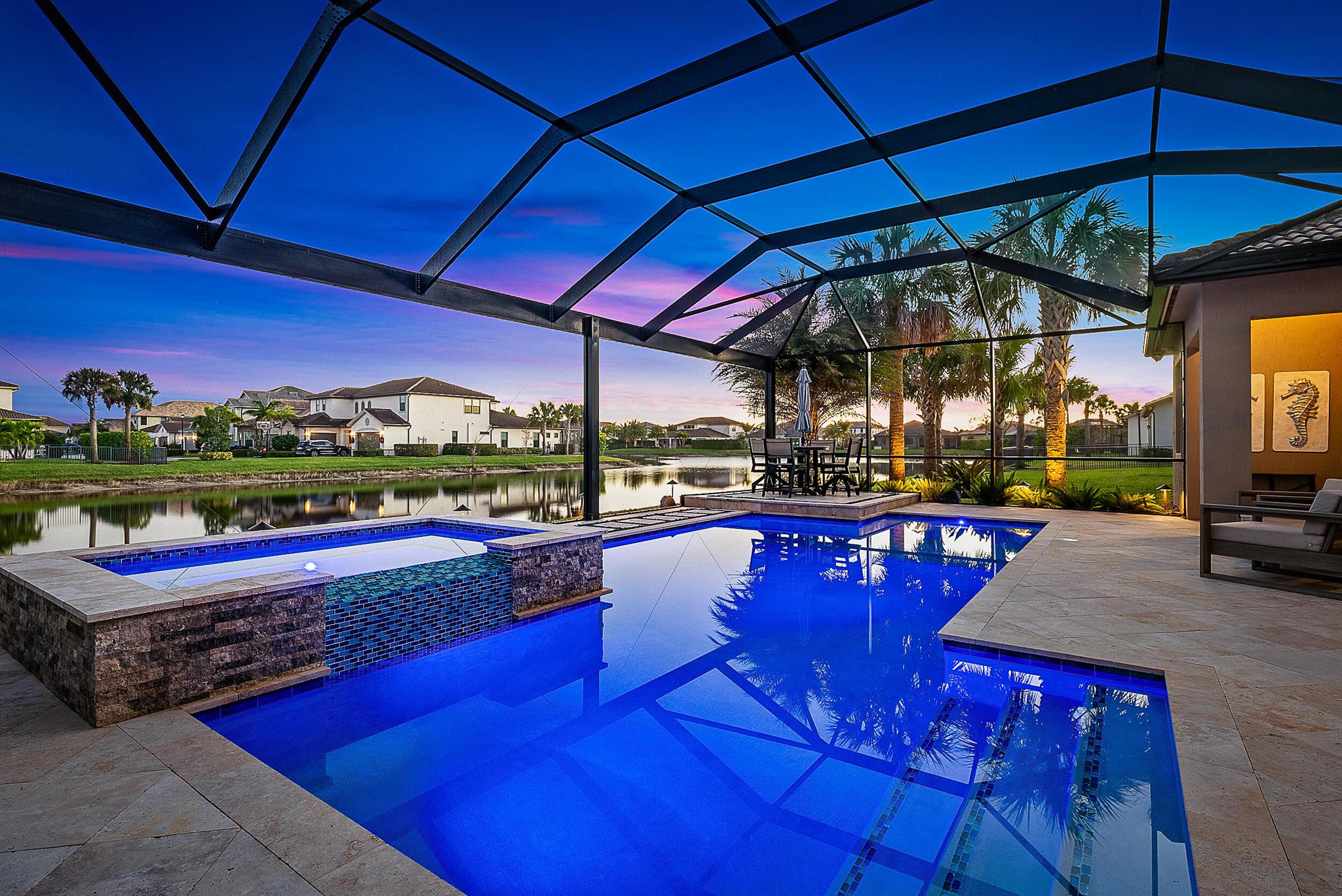 Presenting a stunning five-bedroom plus den smart home nestled on one of the most coveted lots in Sonoma Isles, Jupiter. Surrounded by serene water views & natural preserves, this expansive Clubview model stands as the largest one-level floor plan in the community, meticulously designed & filled with luxurious upgrades. The custom saltwater pool, framed by elegant travertine decking, offers a private oasis, complemented by a fully equipped outdoor kitchen--perfect for alfresco dining & entertaining. Inside, the chef's kitchen dazzles with premium KitchenAid appliances, double ovens, custom cabinetry, & a marble backsplash--a dream for any culinary enthusiast. Seamlessly blending indoor & outdoor living, the home features a zero-corner sliding door that opens to an entertainer's paradise.