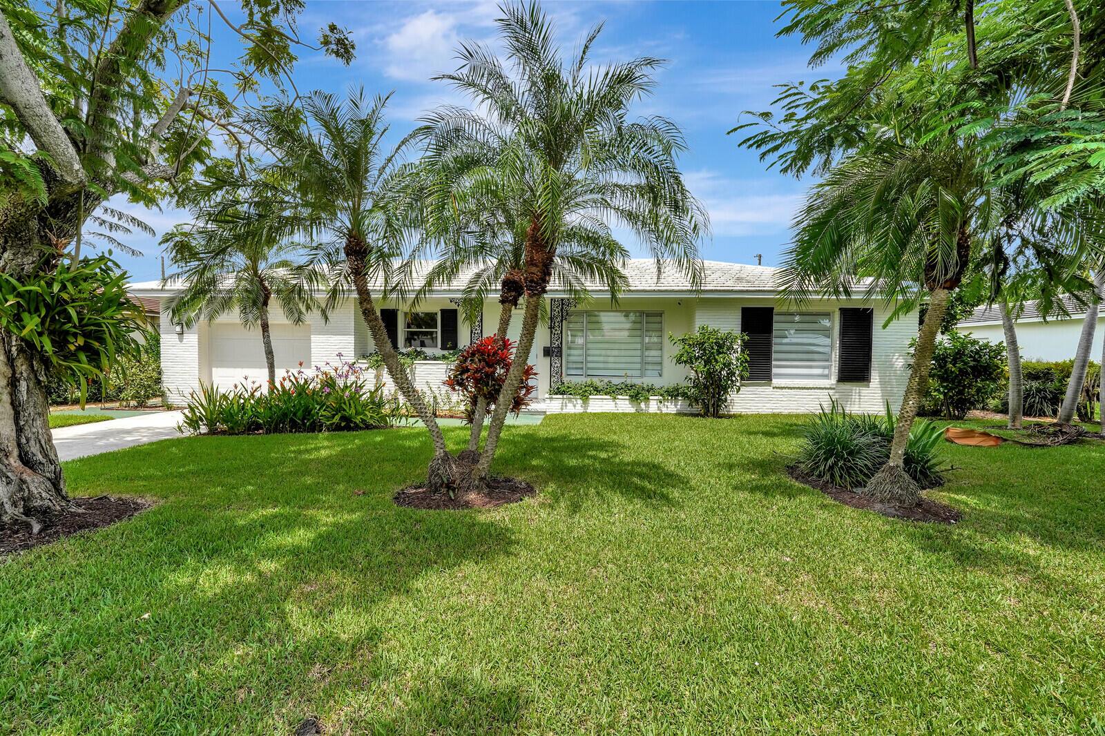 Experience a dream lifestyle in this Mid-Century gem, now available for rent! Located steps from an enchanting Intracoastal-view park and zoned for a top-rated school district, this home offers both convenience and excellence in education. Inside, indulge in the luxury of a renovated kitchen and bathroom. The third bedroom's versatility allows it to serve as a mother-in-law suite or office, perfect for accommodating guests or your work-from-home needs. Original terrazzo floors and an outdoor shower add character and charm. Your private oasis awaits in the fenced yard and covered patio, perfect for al fresco dining. With a one-car garage and solid concrete construction, practicality and durability are assured. Nearby South Olive Park offers endless outdoor adventures.