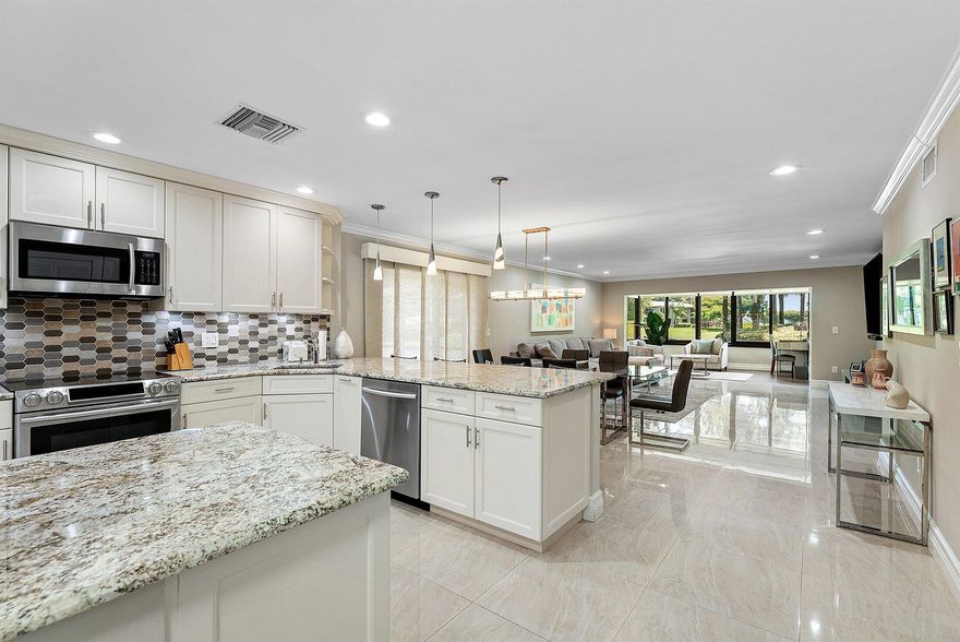 Experience luxurious living in this beautifully renovated 1st floor corner condo, ideally located just steps from the subdivision pool in highly sought-after Hunters Run Country Club — where every day feels like a vacation. This light-filled, open-concept home features an elegant, eat-in kitchen w/ a breakfast bar peninsula and premium finishes, flowing seamlessly into the spacious great room. Crown molding, custom lighting and gleaming tile flooring extend throughout. The guest bedroom is equipped with a convenient Murphy bed. Enjoy indoor-outdoor living w/ a screened-in side patio, plus an open rear patio offering breathtaking views of rolling hills and the South golf course. INCLUDES a separate GOLF CART PATIO w/ electrical hook-up and privacy hedges. 2023 A/C. Newer roof. Such BLISS! Live the country club lifestyle with 3 championship golf courses, tennis & pickleball, resort-style pools, bars, lounges and dining venues, fitness, spa, and a vibrant social sceneall within the gates of Hunters Run Country Club. Beyond the gates, enjoy the close proximity to downtown Delray Beach and the Ave., boating on the Intracoastal waterways, and soaking up the sun-drenched beaches. All just moments away.