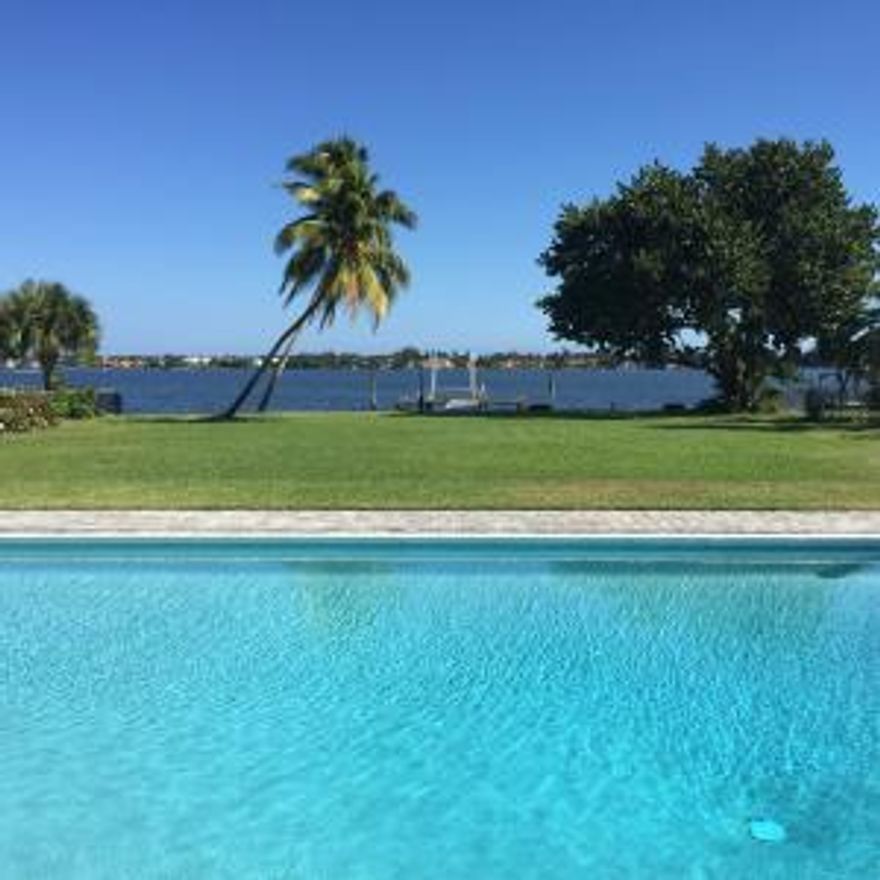 Spectacular views from this charming Bermuda style home sitting on this 2/3 acre direct Intracoastal lot. Deep dock with electric boat lift.