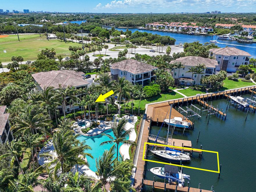 Bring your boat today! Perfectly positioned along a private canal just off the Intracoastal, this residence includes your own deeded 45 foot dock with water/electric hookups accommodating vessels up to 65 feet, offering direct boating access to both Jupiter and Lake Worth Inlets. Discover the pinnacle of waterfront living in this rare offering within the prestigious, gated community of Frenchman's Harbor.  Inside, a light-filled, open layout welcomes you with neutral tile flooring throughout the main living areas, plantation shutters, and impact-rated windows and doors. The spacious living room flows seamlessly into the dining area and gourmet kitchen, creating an ideal space for entertaining. The kitchen features granite countertops, rich wood cabinetry with crown molding, stainless steel appliances including a gas cooktop, and a large center island with extra storage and prep space.  The expansive primary suite offers direct patio access, a large walk-in closet with custom shelving, and a luxurious bathroom with dual vanities, a soaking tub framed by windows, a walk-in glass shower with built-in bench, and a dedicated makeup/dressing vanity.   Secondary bedrooms provide comfort and flexibility, while a French-door office/den offers the perfect setup for working from home. The guest bathroom includes a dual-sink granite vanity and a walk-in tub/shower combo. A laundry room with washer, dryer, and storage completes the interior.  Outdoor living is equally inviting, with a covered brick-paver patio, ceiling fan, and lush tropical landscaping providing the perfect setting for morning coffee or evening gatherings. A two-car garage plus additional driveway parking ensures convenience for both residents and guests.  Frenchman's Harbor is an intimate enclave of just 30 carriage homes and 48 single-family residences, designed for those who value privacy, security, and an active waterfront lifestyle. Community amenities include a resort-style waterfront pool, private boardwalk, and meticulously maintained tropical grounds. From here, you're just minutes to Juno Beach, the Gardens Mall, world-class golf, upscale dining, and Palm Beach International Airport.  Protected canal-front docks keep your boat sheltered from Intracoastal traffic, while fuel docks and marine services are close at hand. Whether your day calls for cruising to waterfront restaurants, exploring nearby sandbars, or relaxing by the pool, this is refined coastal living at its finest - serene, secure, and superbly located.