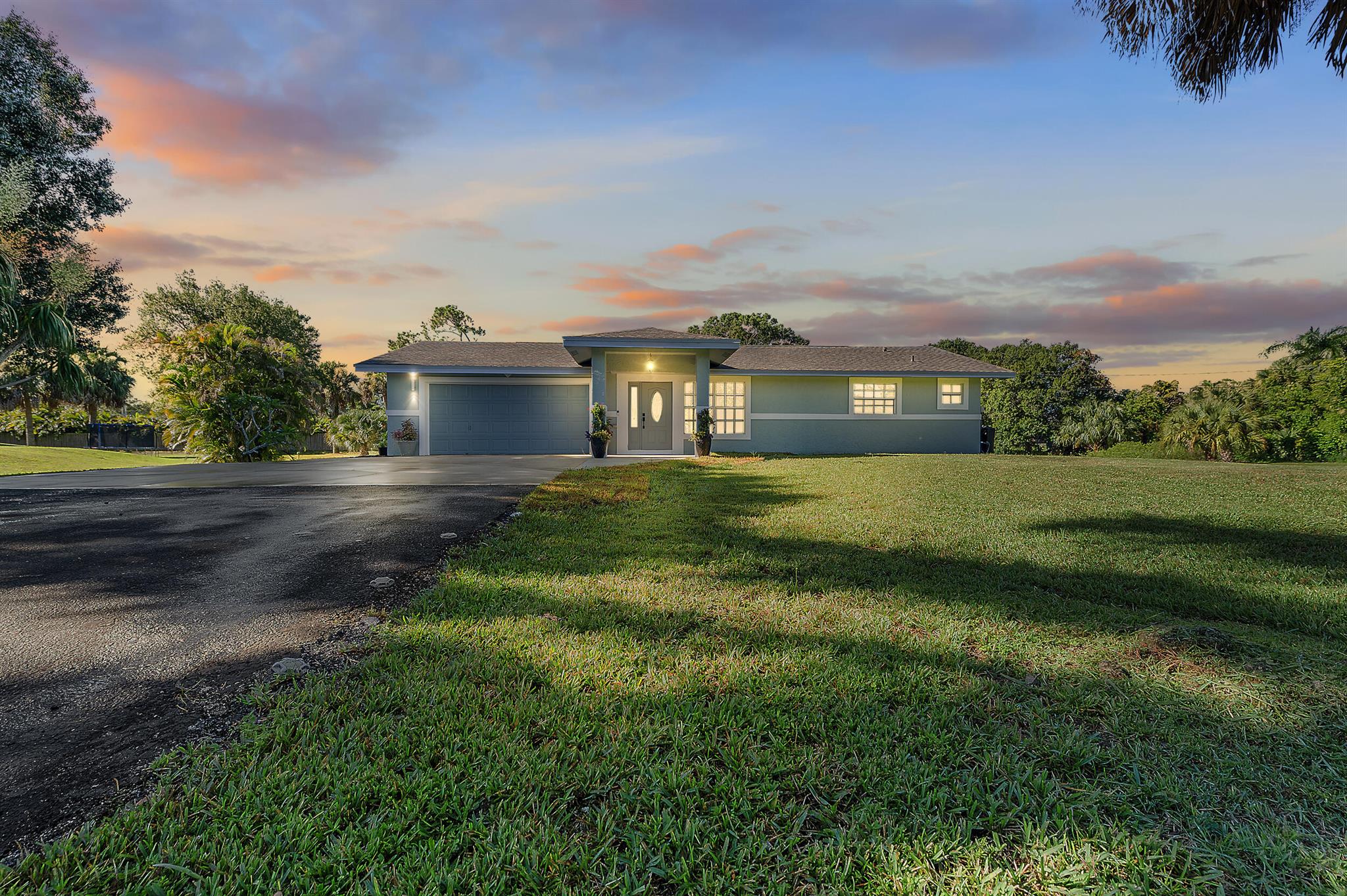 Welcome to this beautifully remodeled 3-bedroom, 3-bathroom home with a two-car garage, set on 1.15 acres in The Acreage. A brand-new roof (February 2025) and updated interiors make this property fully turnkey, offering peace of mind and modern comfort. Located on a paved road within a desirable, developing area, the home combines privacy with convenience. Surrounded by open space, it provides a lifestyle of relaxation with room to expand--perfect for enjoying the quiet of The Acreage while still having a fresh, move-in-ready home.
