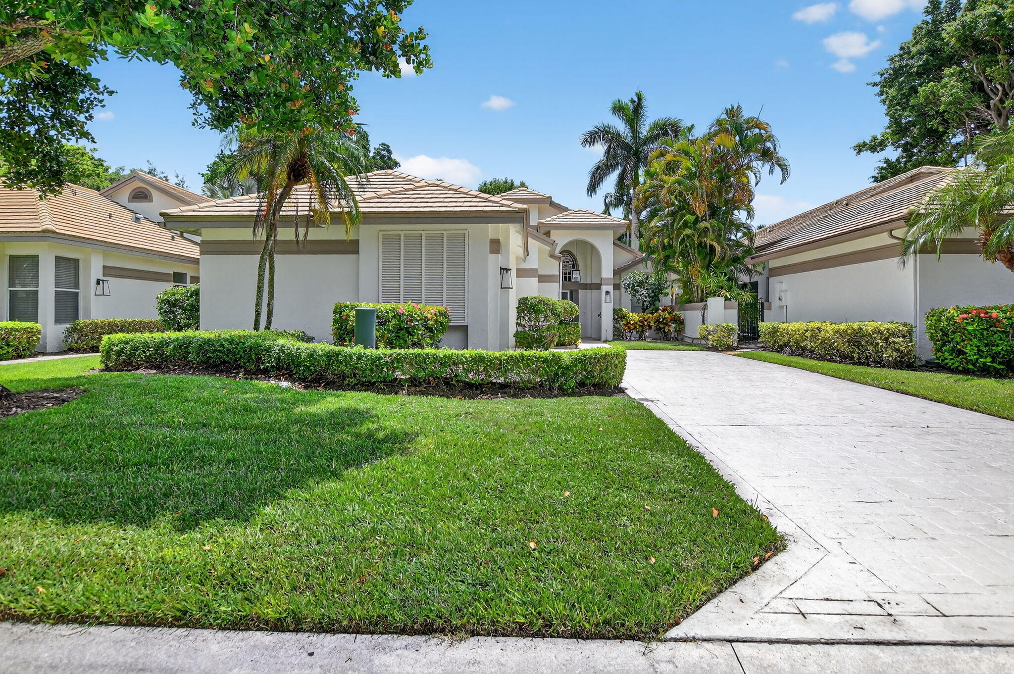 Welcome to this stunning one-story single-family home located in the desirable Village of Whisper Trace within the prestigious Broken Sound Country Club. Offering 1,838 square feet of beautifully updated living space, this 3-bedroom, 2-bath home features a thoughtfully designed split-bedroom floor plan and soaring vaulted ceilings that enhance the bright, open feel throughout. The renovated kitchen is a chef's dream, showcasing sleek white high-gloss cabinetry, elegant quartz countertops, and modern finishes. New flooring flows throughout the home, while both bathrooms have been tastefully upgraded with frameless glass shower doors and stylish fixtures. Step outside to your own private oasis -- a fenced backyard with a sparkling pool, perfect for relaxing or entertaining in complete