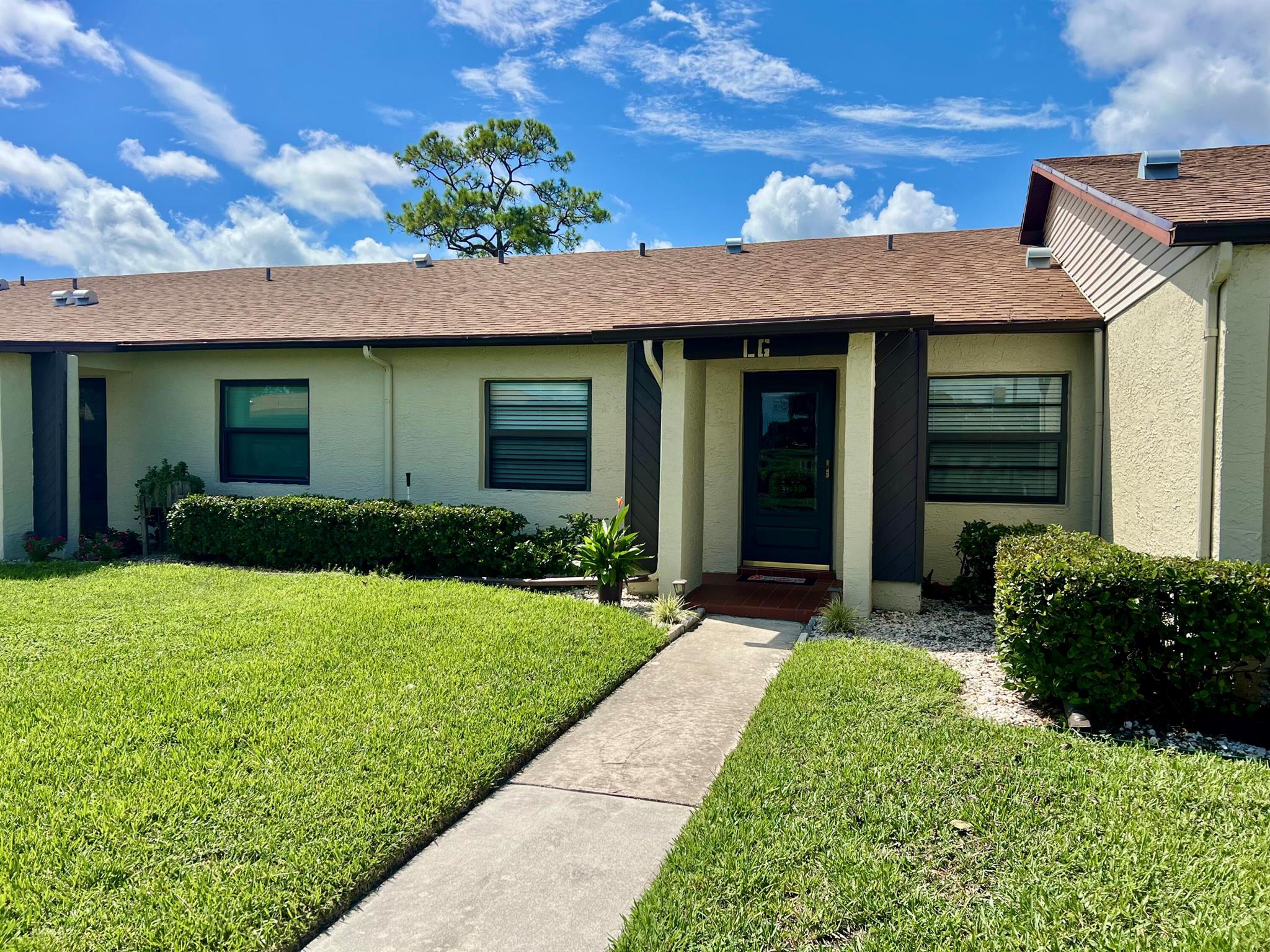 Welcome to this beautifully updated condo in the desirable Indian Pines Village! This move-in-ready home features a freshly painted interior and completely remodeled bathrooms with new showers, bathtubs, vanities, countertops, and modern fixtures. The kitchen shines with stainless steel appliances, while new electrical switches, dimmers, and lighting add a sleek, contemporary touch throughout. Popcorn ceilings have been removed for a smooth finish, and the entrance has been upgraded with a hurricane impact door, storm door, and impact-resistant windows. Enjoy added comfort with new ceiling fans, a private restored patio, and the convenience of an in-unit washer and dryer. Major updates include AC (2017), water heater (2017), and a brand-new roof (12/2023).