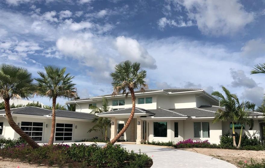 Transitional contemporary golf course home. From the roof to the floors, everything is new. Gut-renovated 3 bedroom, 3.5 bath house w den/office. 7,525 sf in total, 5,186 sf under air. Soaring 20' ceilings in the living room/dining room area. Huge pool deck lanai featuring 20' tall, exposed wood ceilings, custom made fire pit, summer kitchen, large pool & spa. Top of the line appliances including Sub-Zero built-in fridge/freezer, dishwasher, gas cooktop with electric ovens in the Wolf 48'' range, & microwave. Impact windows & doors. Oversized master bedroom suite w private elevator, his & her walk-in closets, his & her WC's, soaking tub, large shower, coffee bar & balcony. Incredible views of the pool area, golf course & glimpses of the ocean. 2.5 car air-conditioned garage.