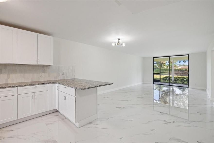 Stunning renovated 2 BEDROOM / 2 BATHROOM FIRST FLOOR condo unit PICTURESQUE VIEW OF GOLF-COURSE in The Palms, Deer Creek Country Club!  This is a NON MANDATORY MEMBERSHIP community but offers golf packages for those who wish to play. Contact the Deer Creek Florida Golf Club for more information.The NEWLY RENOVATED OPEN KITCHEN features GRANITE countertops, modern backsplash and NEVER USED STAINLESS STEEL appliances. GORGEOUS POLISHED 32 x 32 MODERN PORCELAIN TILES THROUGHOUT THE CONDO and large PORCELAIN tiles also on the walls of bathroom! No thick grout lines!  Condo Association amenities include: pool, tennis, gym, bocce ball & shuffleboard courts, car wash area and more!  Don't miss out on the chance to make this remarkable property your own!