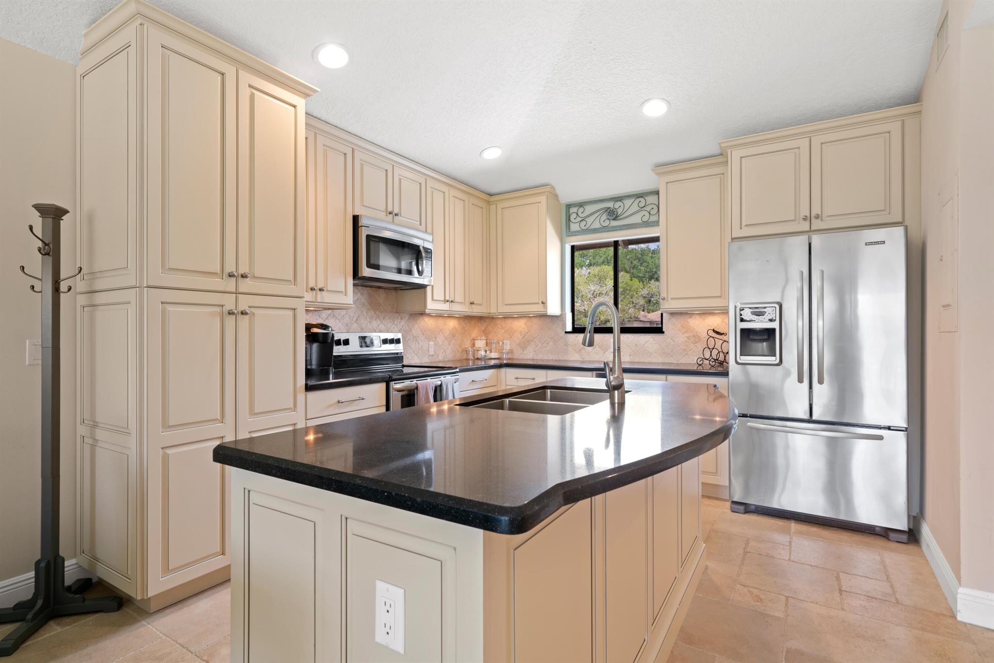 Spectacular turnkey 2BR/2BA Club Cottage with serene canal views. Features stunning travertine marble floors, fully equipped kitchen with custom self-closing cabinets, pantry, pull out shelves, granite counters, tumbled marble backsplash, and stainless steel appliances. Both bathrooms are exquisitely renovated, master has frameless walk-in shower, guest bath offers tub/shower. Master bedroom includes a king bed, guest has queen. Spacious living area with elegant furnishings. Enjoy open patio with water view. One block from the community pool which offers bathrooms, shaded seating and viewing deck. Minutes to golf, dining, shopping, trails, playgrounds, PBI and all Palm Beach Gardens has to offer. No rental restrictions. Currently successful VRBO rental.