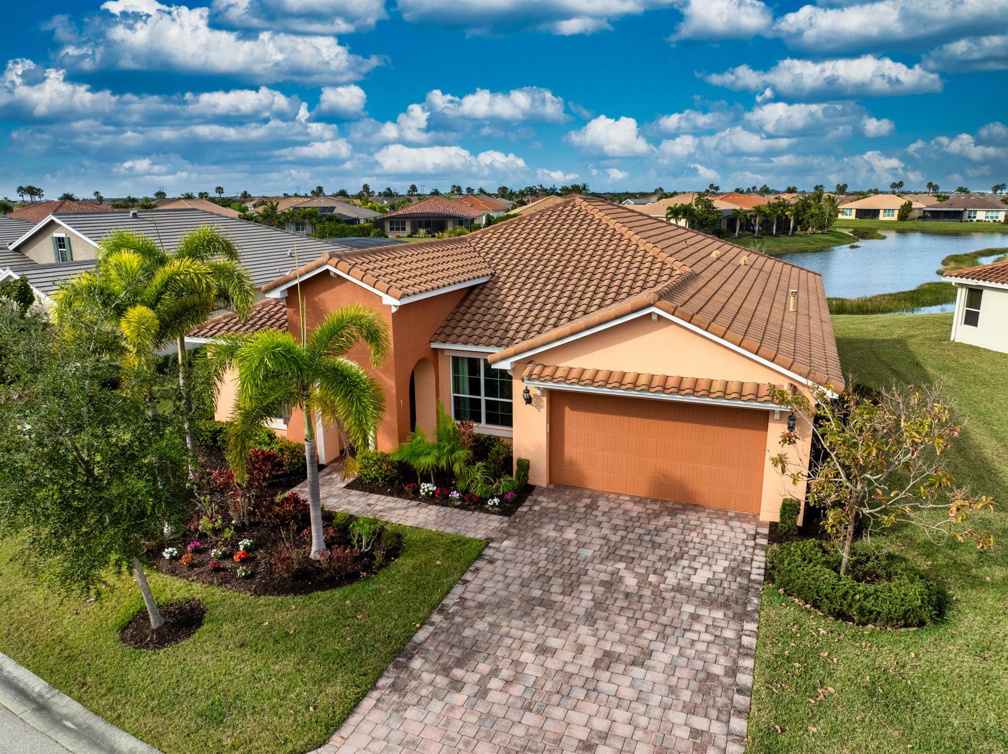 This elegant 4-bedroom, 3-bathroom home with a dedicated den offers over 2,400 square feet of luxurious living space, perfectly designed for comfort and style. From the moment you step inside, you're greeted by breathtaking long lake views that serve as the backdrop to the open family room and stunning kitchen. The kitchen, designed with entertaining in mind, features premium finishes, a large center island, and seamless sightlines to the main living areas. The expansive master suite offers a private retreat, complete with serene lake views, an oversized walk-in closet, dual sinks, and a spa-like stand-up shower. Three spacious guest rooms are strategically positioned for privacy, making them ideal for family or visitors.