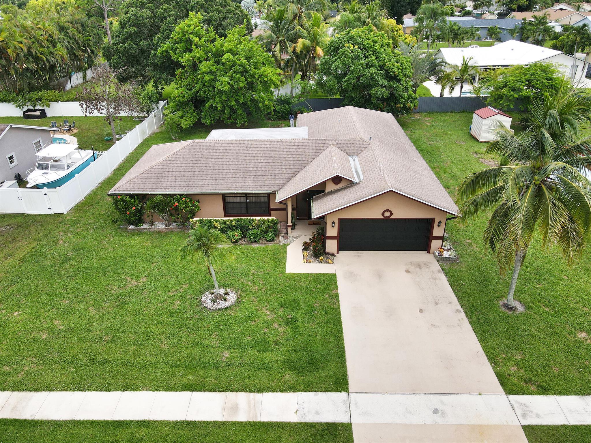 Welcome to 145 Santa Monica Ave, Royal Palm Beach, FL where there is NO HOA! And the schools are ''A'' Rated! This split plan home is situated on a large lot with room for a pool and much more. It has 4 large bedrooms, living room, dining room, and a family room in an open floorplan. There is a large screened, covered patio. The top of line 2010 Trane A/C unit is well maintained and works perfect. The GE water heater is 2010, and a new roof was installed 2020. Enjoy 3 types of mangoes from the mature fruit trees in backyard. La Mancha is one of the most sought-after areas in Palm Beach County. Make your move now!!!!
