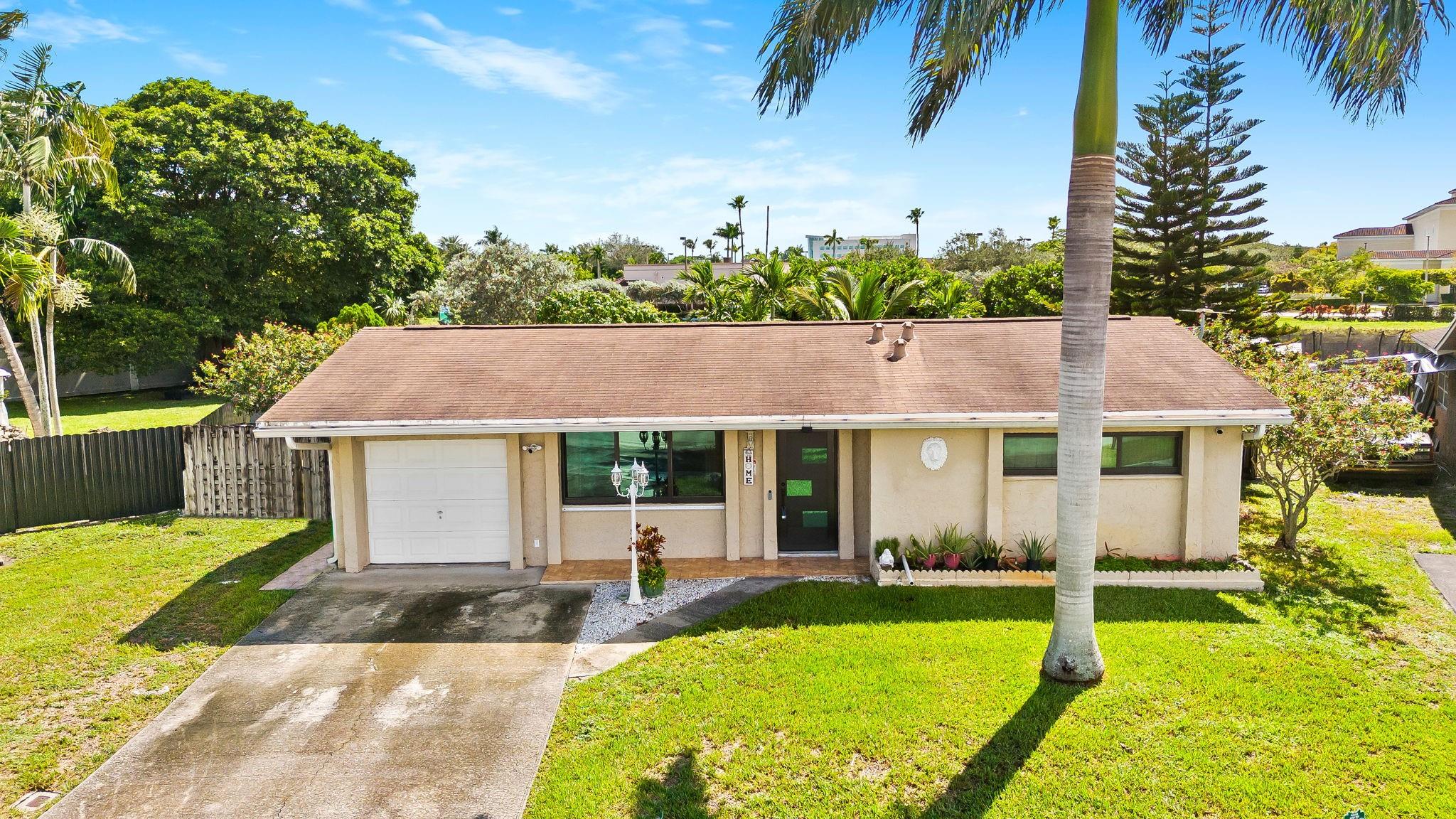 Welcome to Sunrise Golf Village - where you don't have to live by any HOA restrictions. This home is truly one of a kind and has endless opportunities to make it your own! The essentials are all here - 2018 roof, 2019 water heater, and 2025 impact windows and doors (excluding Florida room). An oversized, fully fenced, pie shaped lot spanning nearly 11,000 square feet is full of fruit trees with plenty of space to entertain guests, build a pool or expand your home. There are 3 bedrooms plus a Florida room which currently serves as a 4th bedroom/primary suite with walk-in closet. Other upgrades include freshly painted interior, 2020/24 stainless steel kitchen appliances, renovated bathroom. Conveniently located close to all of the shopping, dining and highways at Sawgrass Mills Mall & Expwy.