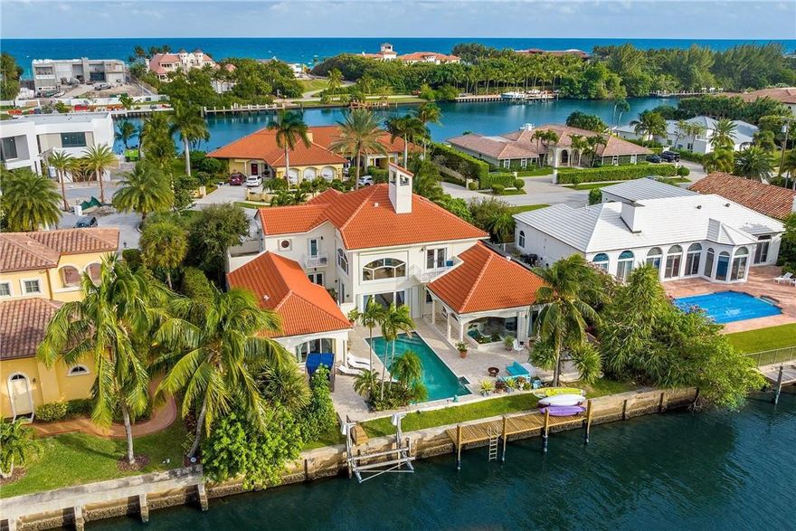 The exclusive subdivision of Point Manalapan serves as an amenity--rich backdrop for this slice of residential paradise. A sprawling 14,251 sq. ft. lot, with 100 feet of water frontage -presents an array of possibilities, whether the intent involves tweaks, renovation, or a complete reimagining. Bright palettes, high ceilings & oversized spaces inside the two-story, 6-bedroom 5.5 bathroom layout enhance the open-air vibe that permeates a contemporary estate spanning over 4,800 square feet. Highlights include: den/office, fireplace, 3 car garage & resort-style pool/spa. Ownership at Point Manalapan has privileges-including access to La Coquille, the members-only beach club within nearby Eau Palm Beach Resort & Spa that offers everything from oceanfront cabana service to world-class dining.