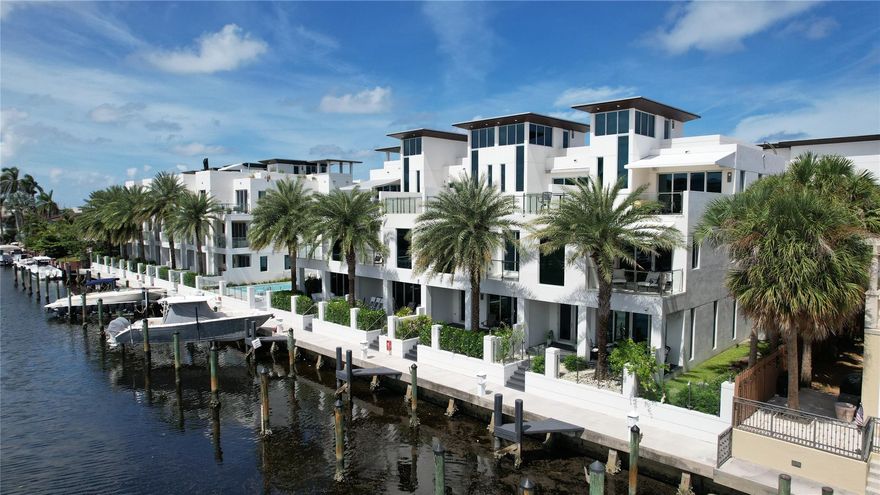 Soon to be a gated community. Luxurious 3-bed, 3.5-bath townhome, just three blocks from the beach, shopping, and dining. This eco-friendly green building, elevated 5 feet above sea level, negates the need for flood insurance. Features include a private elevator, floating staircase, and a "Wired Smart Home" system. The gourmet kitchen boasts Wolf appliances, Sub-Zero refrigeration, and premium Häcker cabinetry. The sky terrace, with a summer kitchen, offers ocean, Intracoastal Waterway, and skyline views. The townhome includes a 35-foot dock with direct ocean access. The primary suite features a private balcony, a luxurious bathroom, and dual vanities. Amenities include a two-car garage, full house Generac generator, infinity pool, and Jacuzzi. Designed by Steven G.