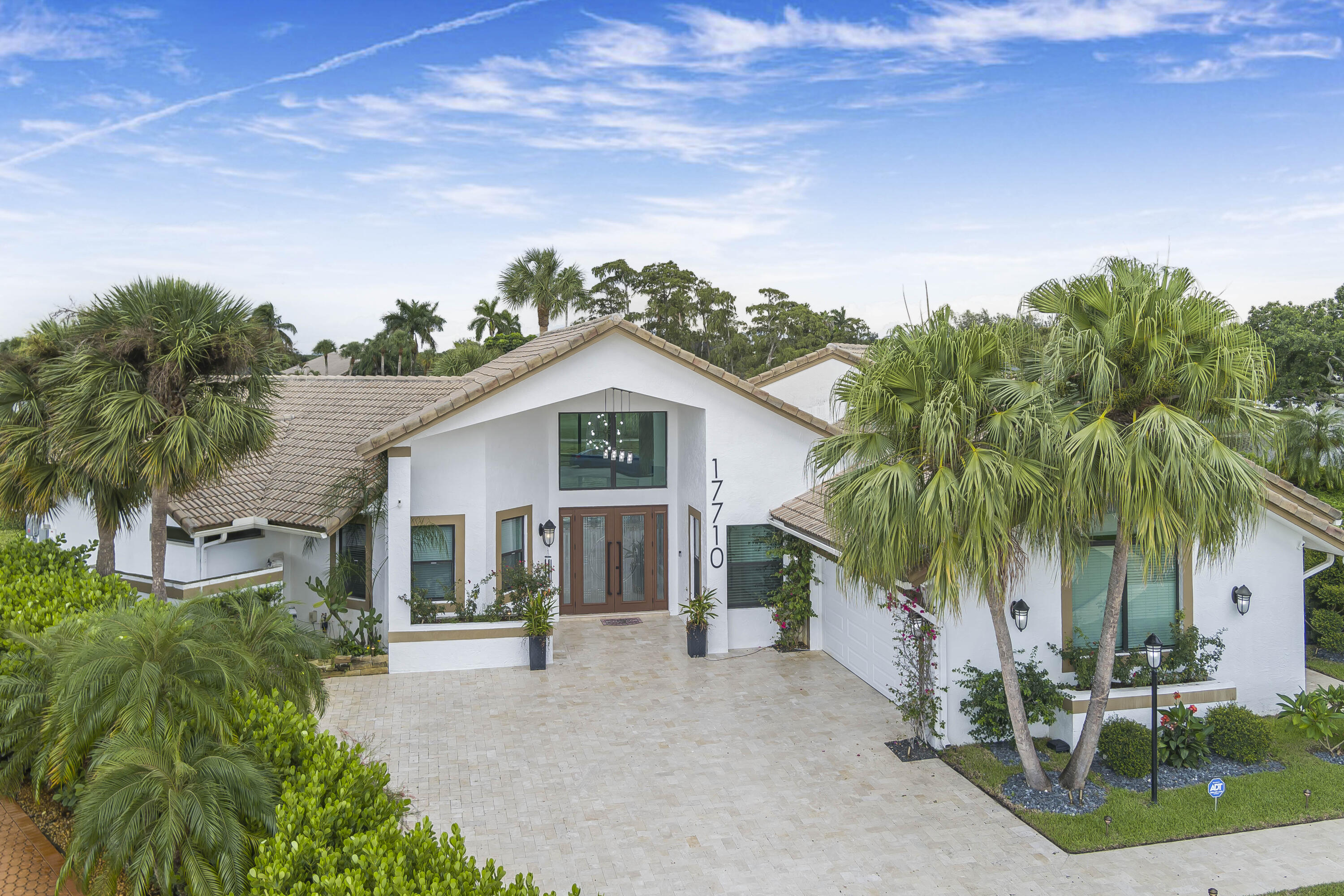 Experience the pinnacle of luxury and lifestyle in this exquisitely remodeled lakefront estate, perfectly positioned on one of the largest lake view cul-de-sac point lots in Stonebridge Country Club's gated community. Spanning over 4,000 sq ft, this stunning home offers 3 bedrooms, a refined office/den, and elegant formal and casual living spaces. The designer kitchen dazzles with a Sub-Zero refrigerator, gas Wolf range, and oversized island. Rich hardwood floors, full impact windows and doors, and energy-efficient solar panels combine beauty with peace of mind. Outdoors, enjoy a spectacular kitchen, covered pergola, and expansive entertaining area with sweeping golf and water views. A beautifully paved driveway creates a grand entry, and the home is offered fully furnished and