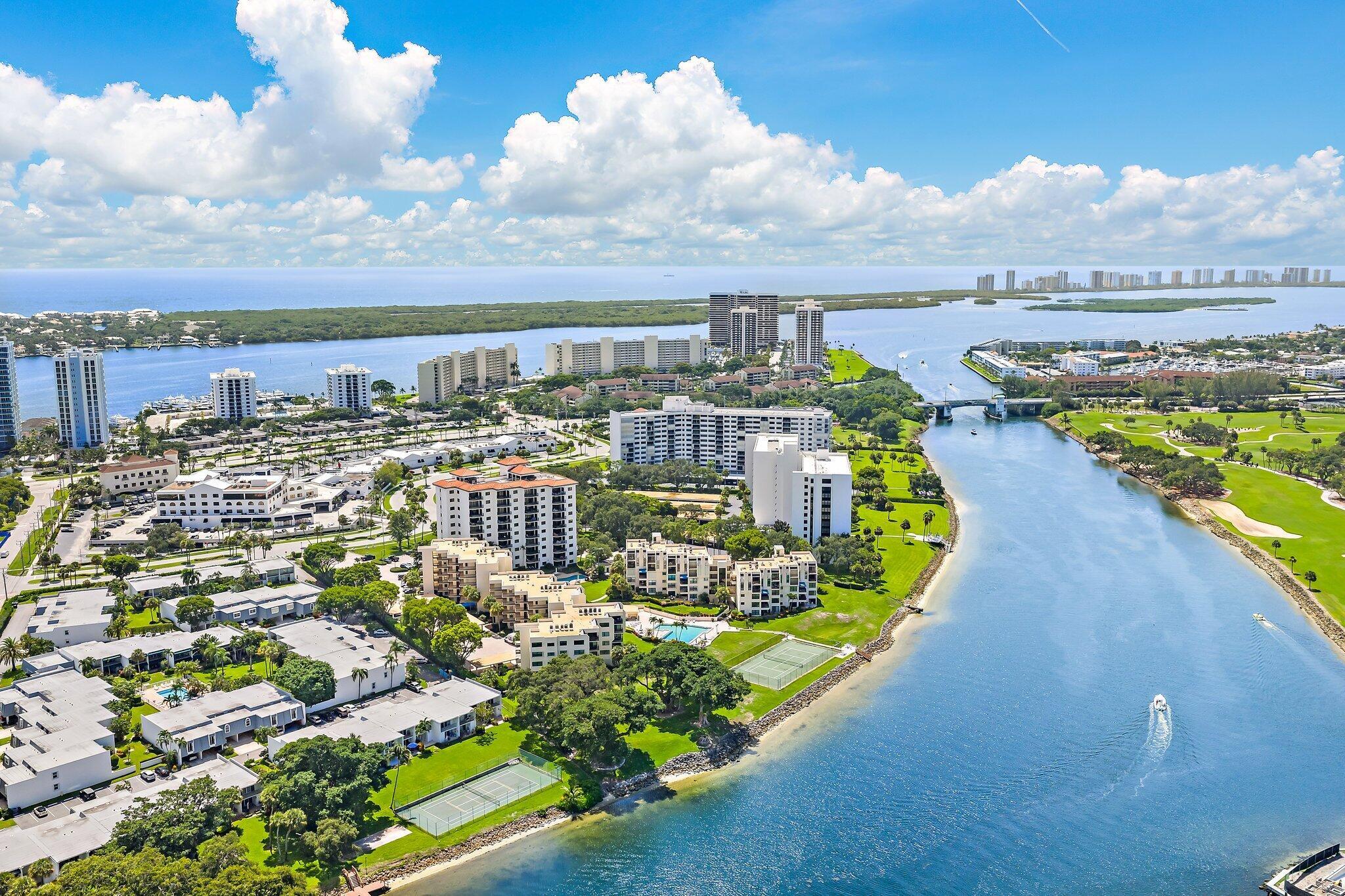 Experience elevated coastal living in this impeccably renovated waterfront residence at Seamark, North Palm Beach. Redesigned in 2020 with the finest finishes, this 2-bedroom, 2-bath condo exudes modern elegance and timeless style. Every detail has been thoughtfully curated, from the sleek tile flooring and smooth ceilings to the impact windows & doors, new A/C, water heater, and premium appliance package.The chef's kitchen is a showpiece, featuring Calcite countertops, natural stone sinks, oversized cabinetry, a custom vent hood, 36'' induction cooktop, double oven, wine cooler, and built-in coffee bar, perfectly blending function with sophistication. Both bathrooms are equally impressive, with quartz counters, upgraded toilets, and an oversized marble shower that adds a spa-like feel.